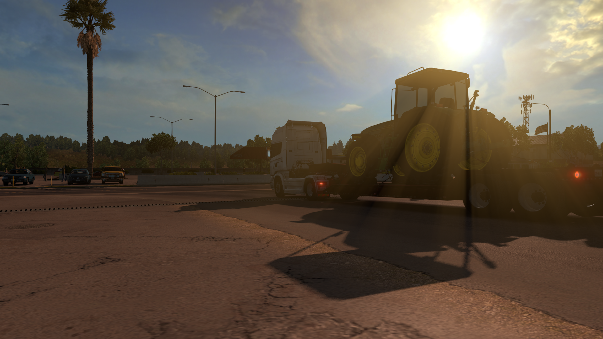 Tractor trailer truck carrying a tractor in American Truck Simulator HD Wallpaper