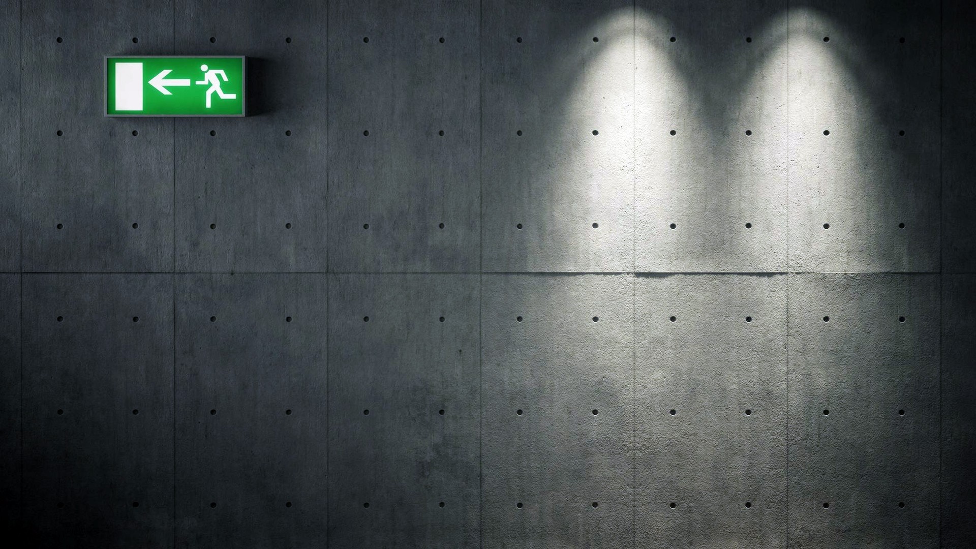 Green exit sign on concrete wall with spotlights HD Wallpaper