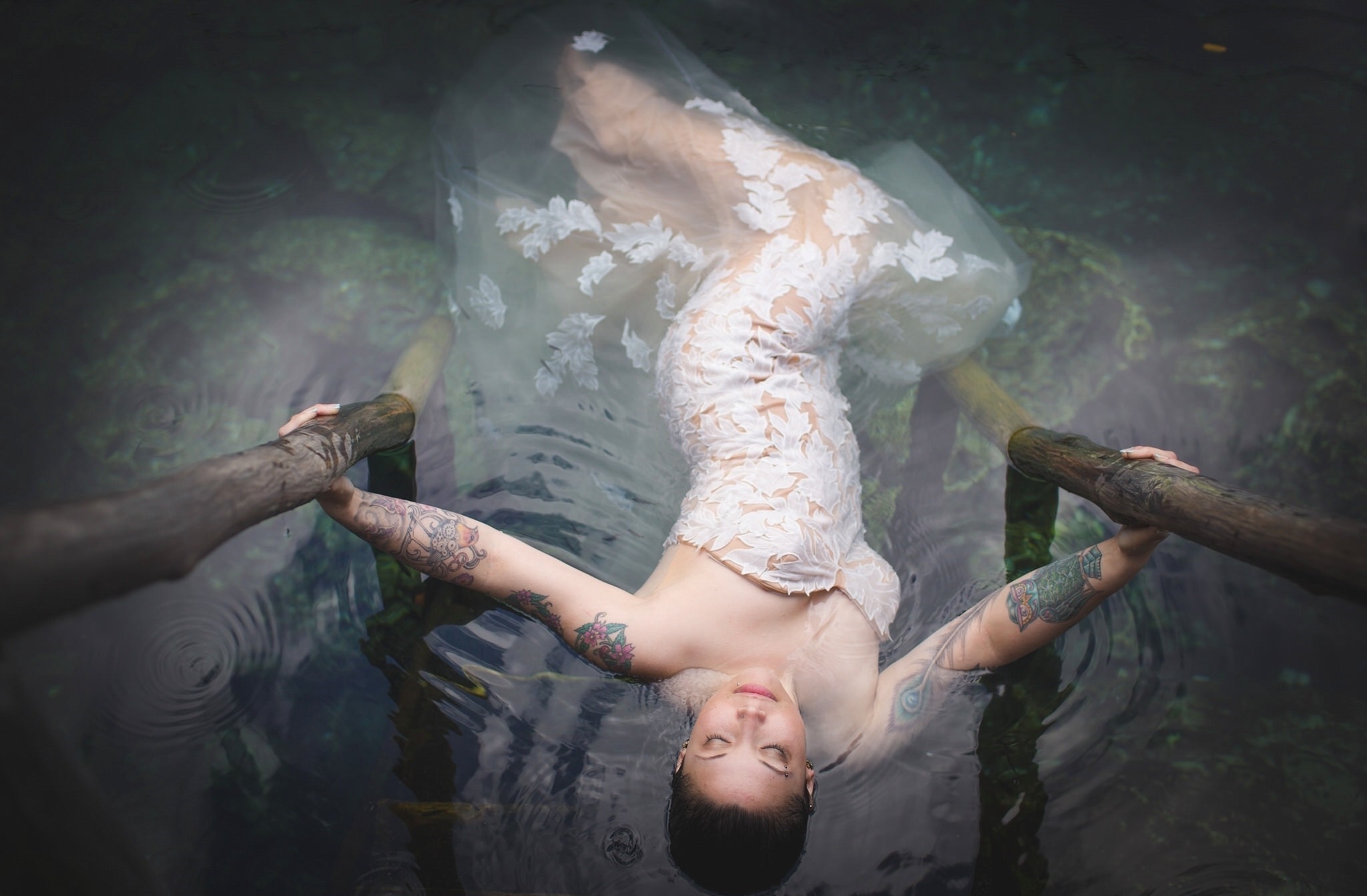 Woman in a white dress floating in water HD Wallpaper