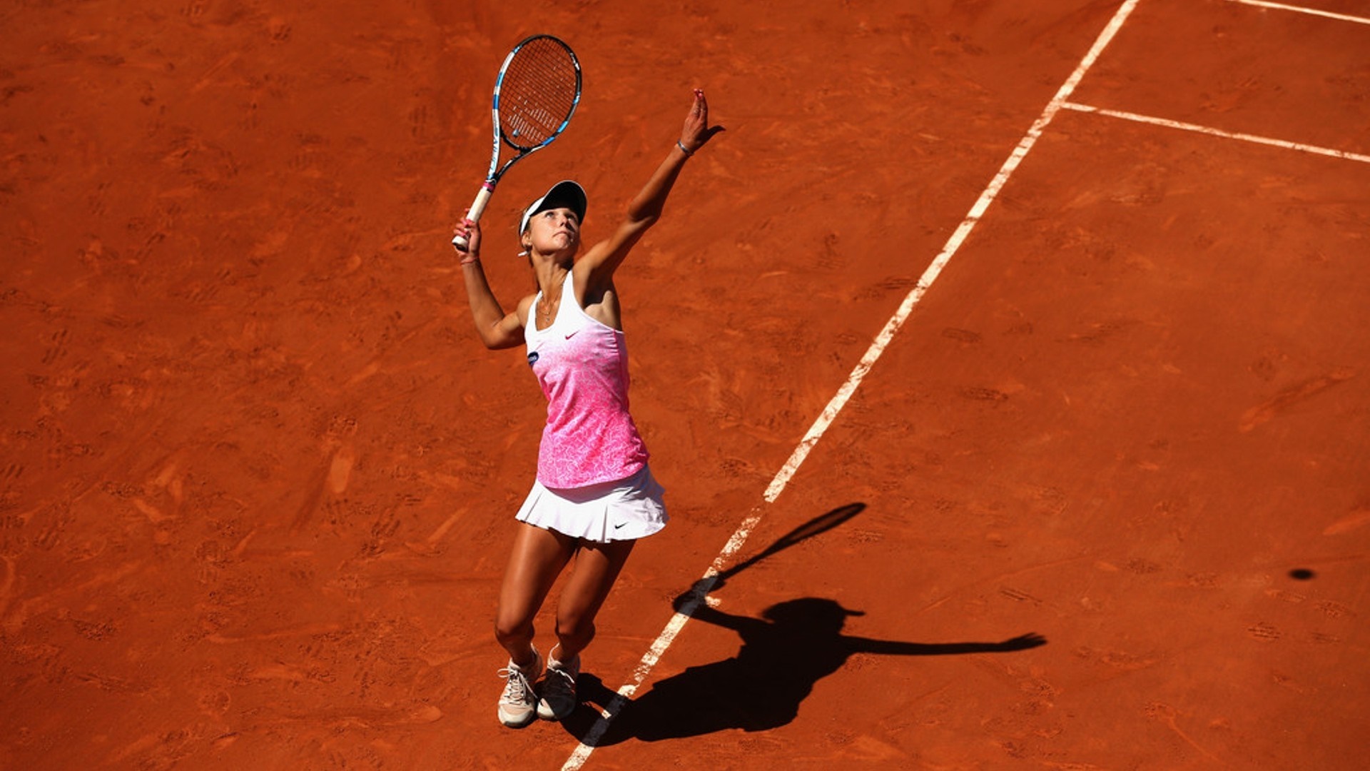 Anna Kalinskaya serving on a clay tennis court HD Wallpaper