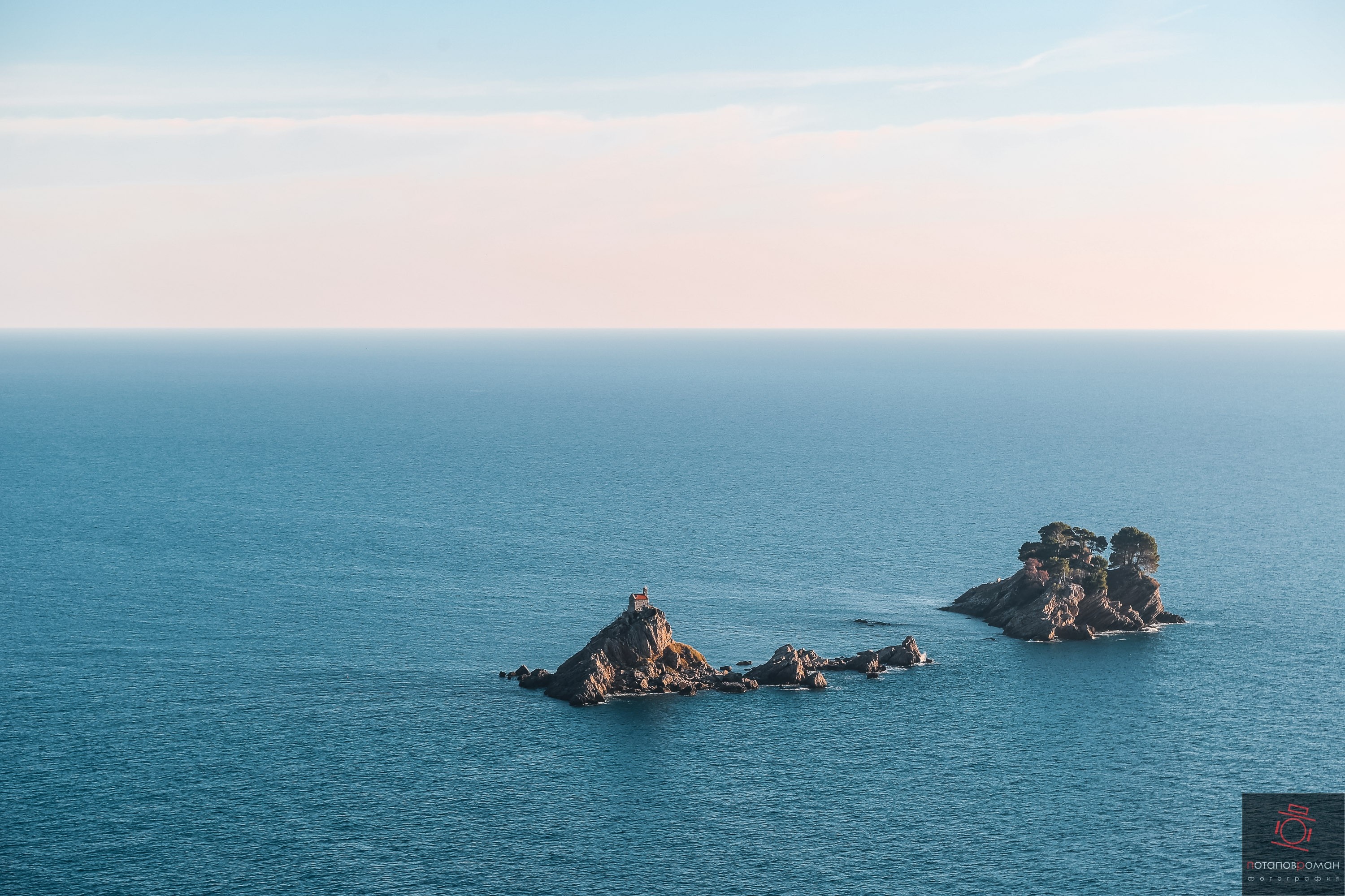 Two rocky islands in the sea with trees HD Wallpaper