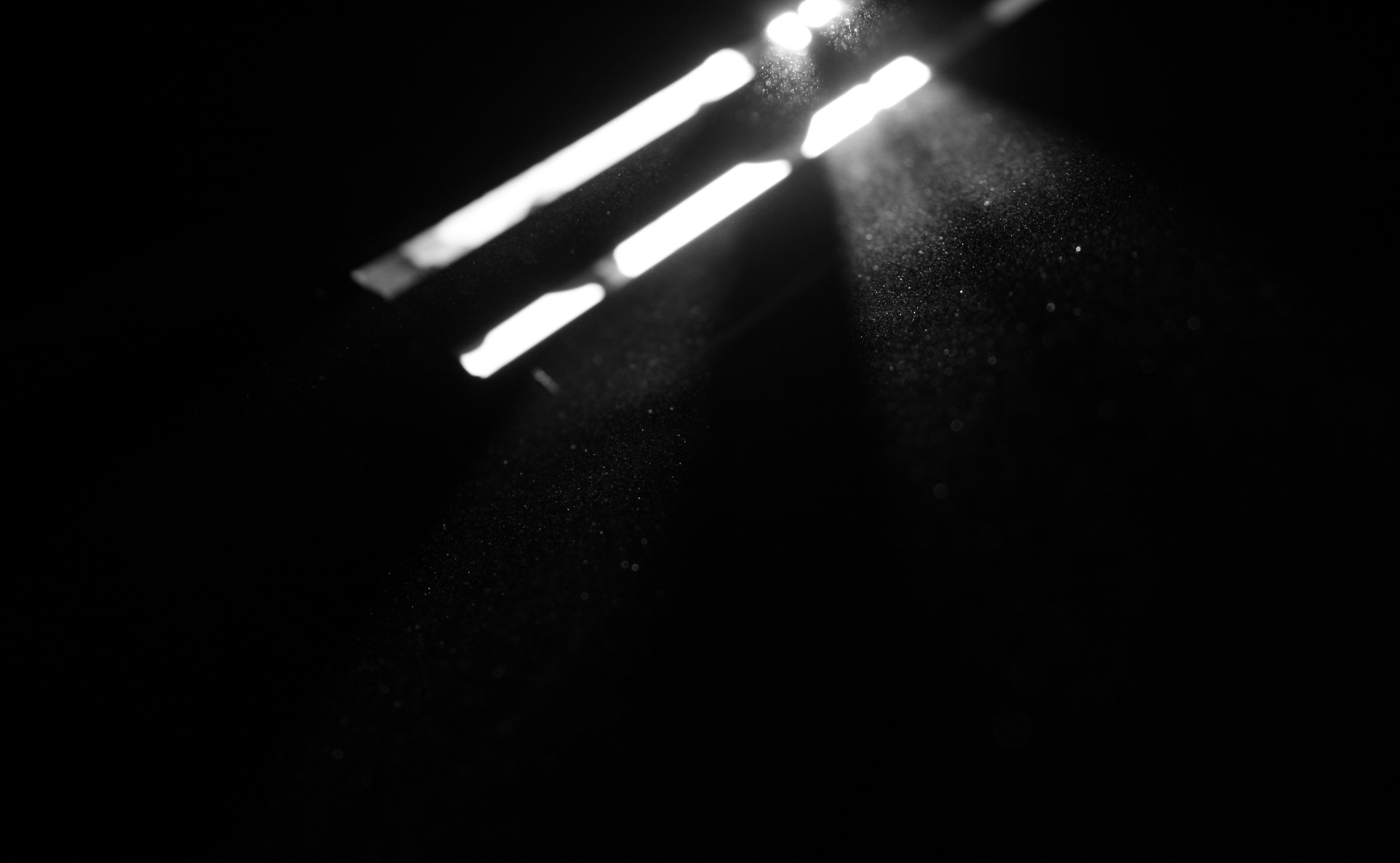 Monochrome image of light beams and dust particles HD Wallpaper
