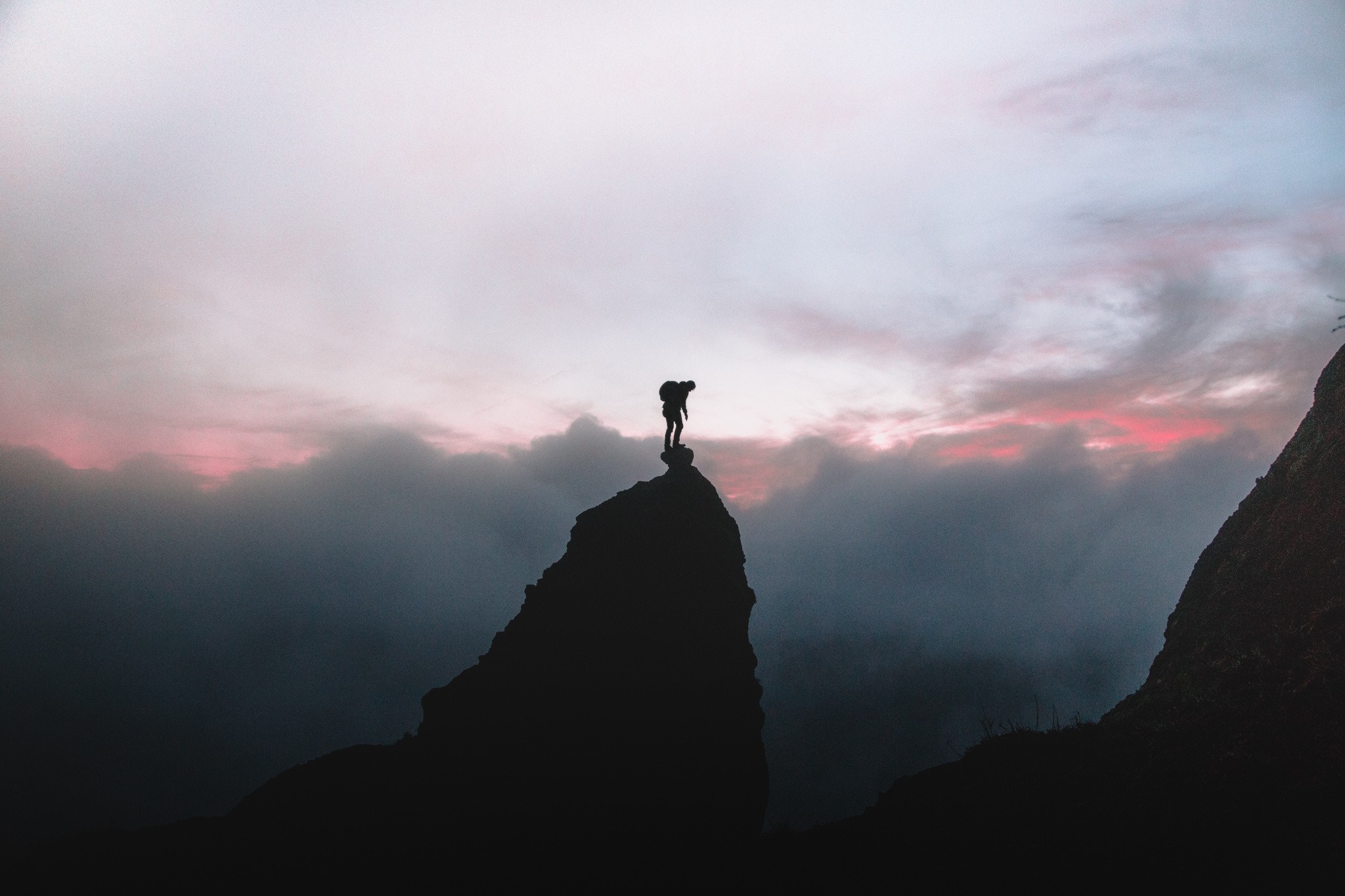Silhouette of a hiker on a mountain peak at sunrise HD Wallpaper