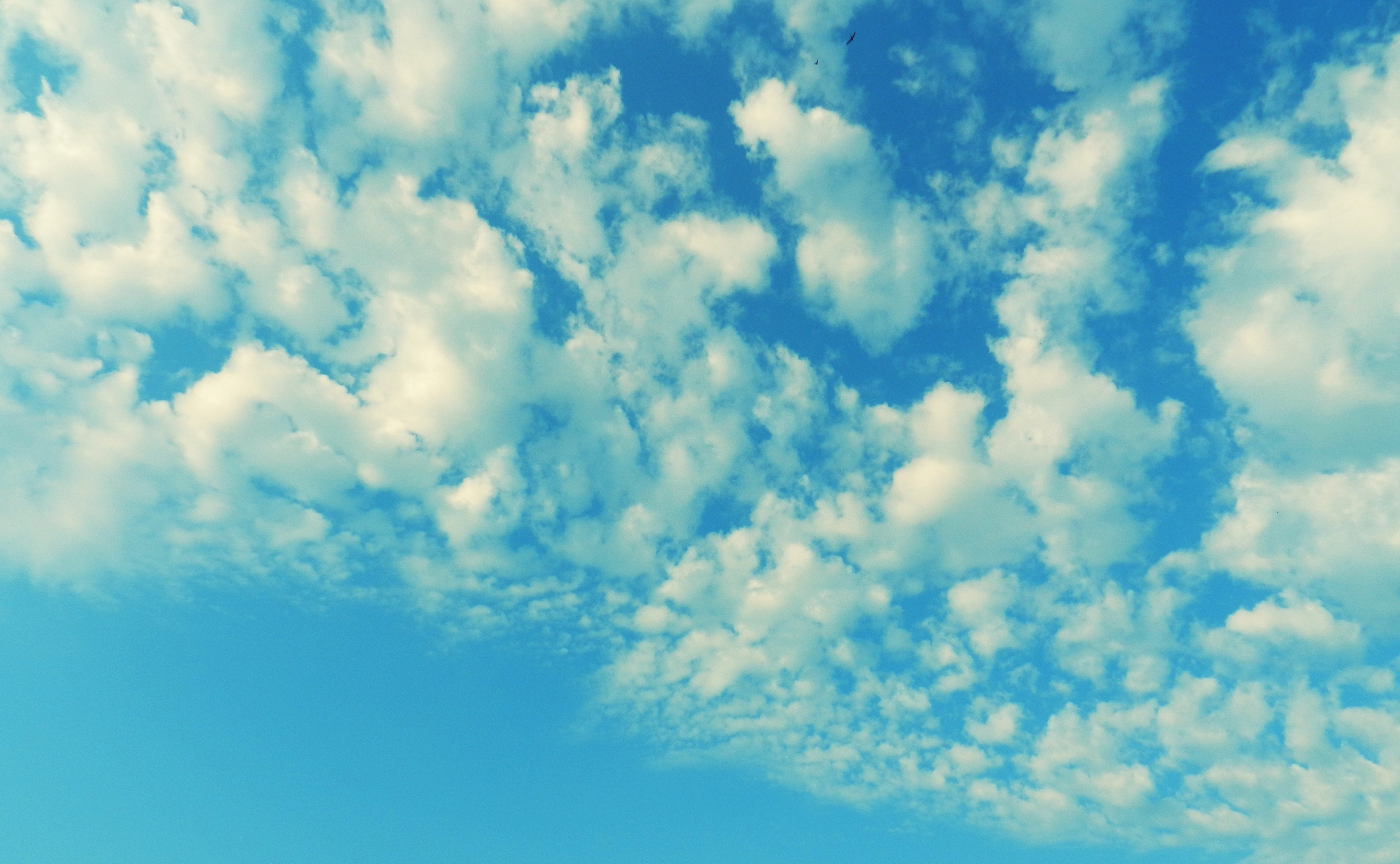 Blue sky with scattered white clouds HD Wallpaper