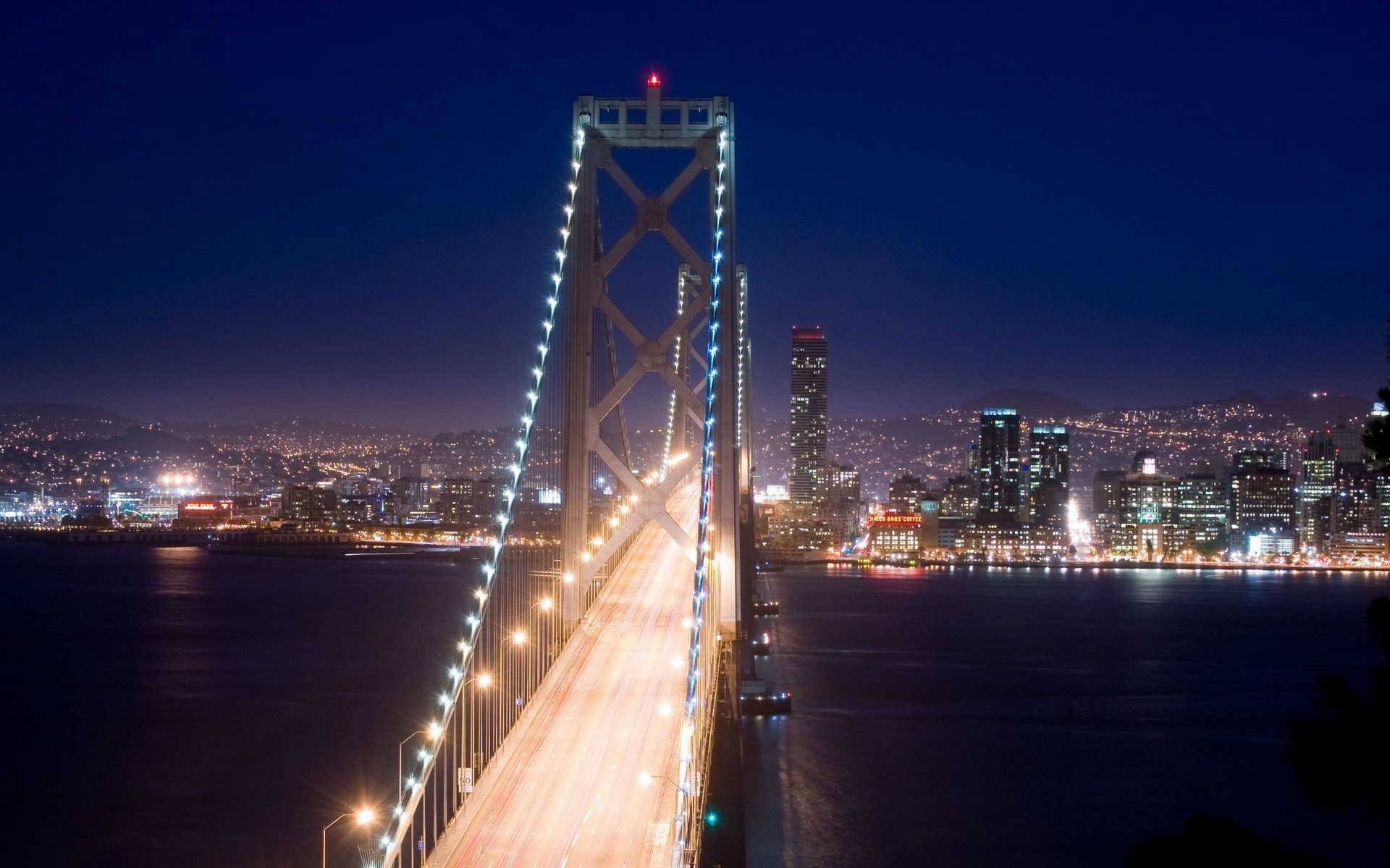 Oakland Bay Bridge at night with San Francisco skyline HD Wallpaper