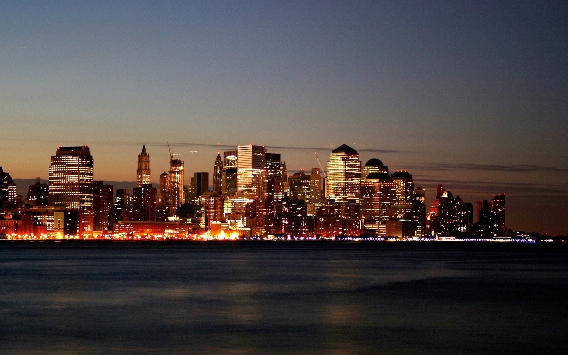 New York City skyline at dusk over the water HD Wallpaper