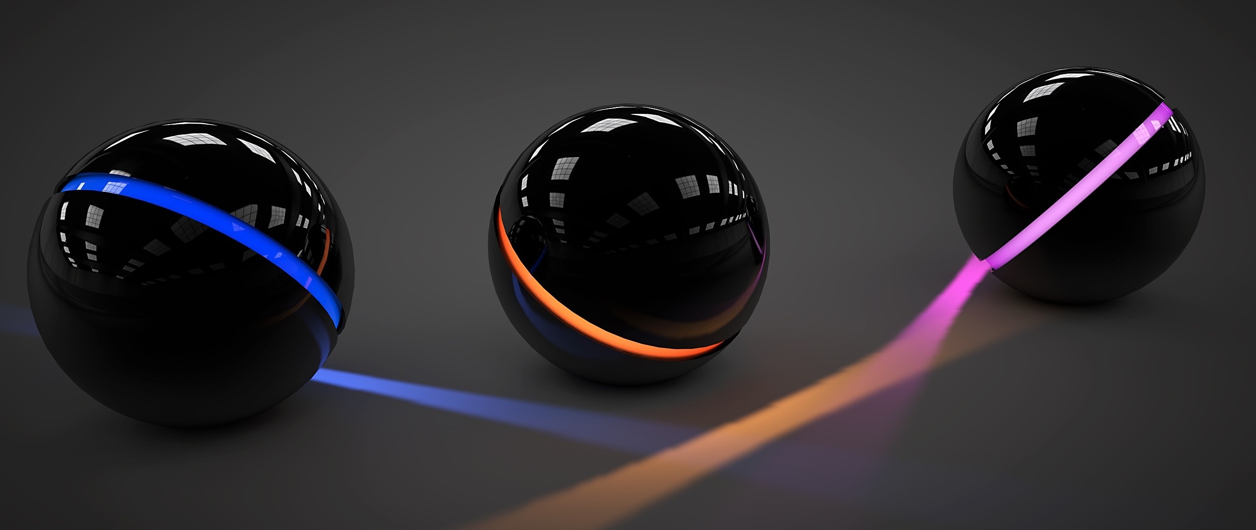 Three black spheres with glowing colored stripes HD Wallpaper