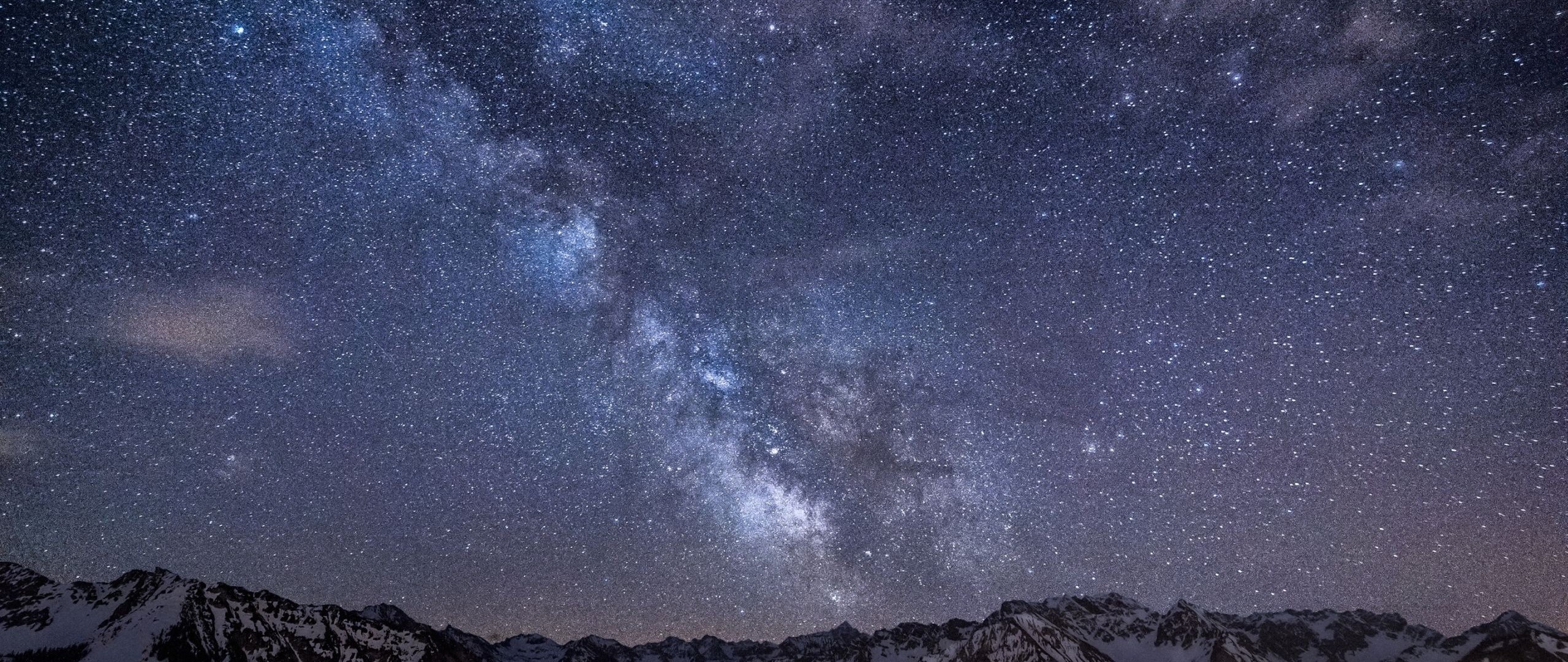 Milky Way galaxy over snow-capped mountains at night HD Wallpaper