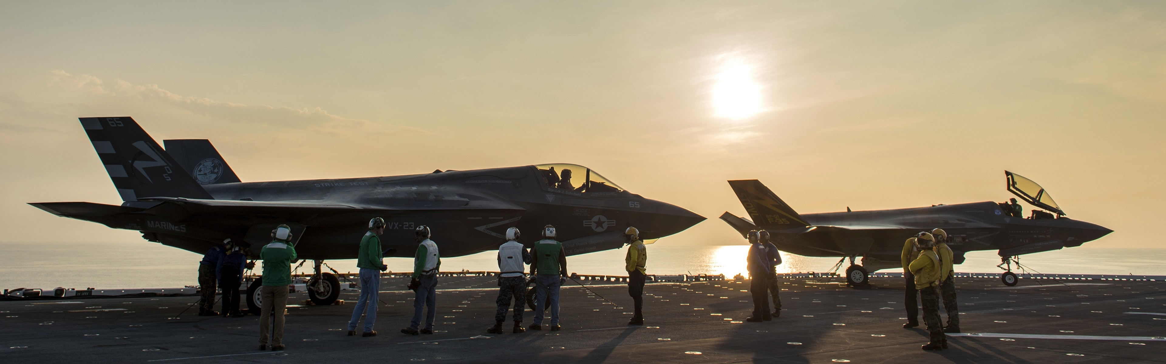 F-35 Lightning II aircraft on an aircraft carrier at sunset HD Wallpaper