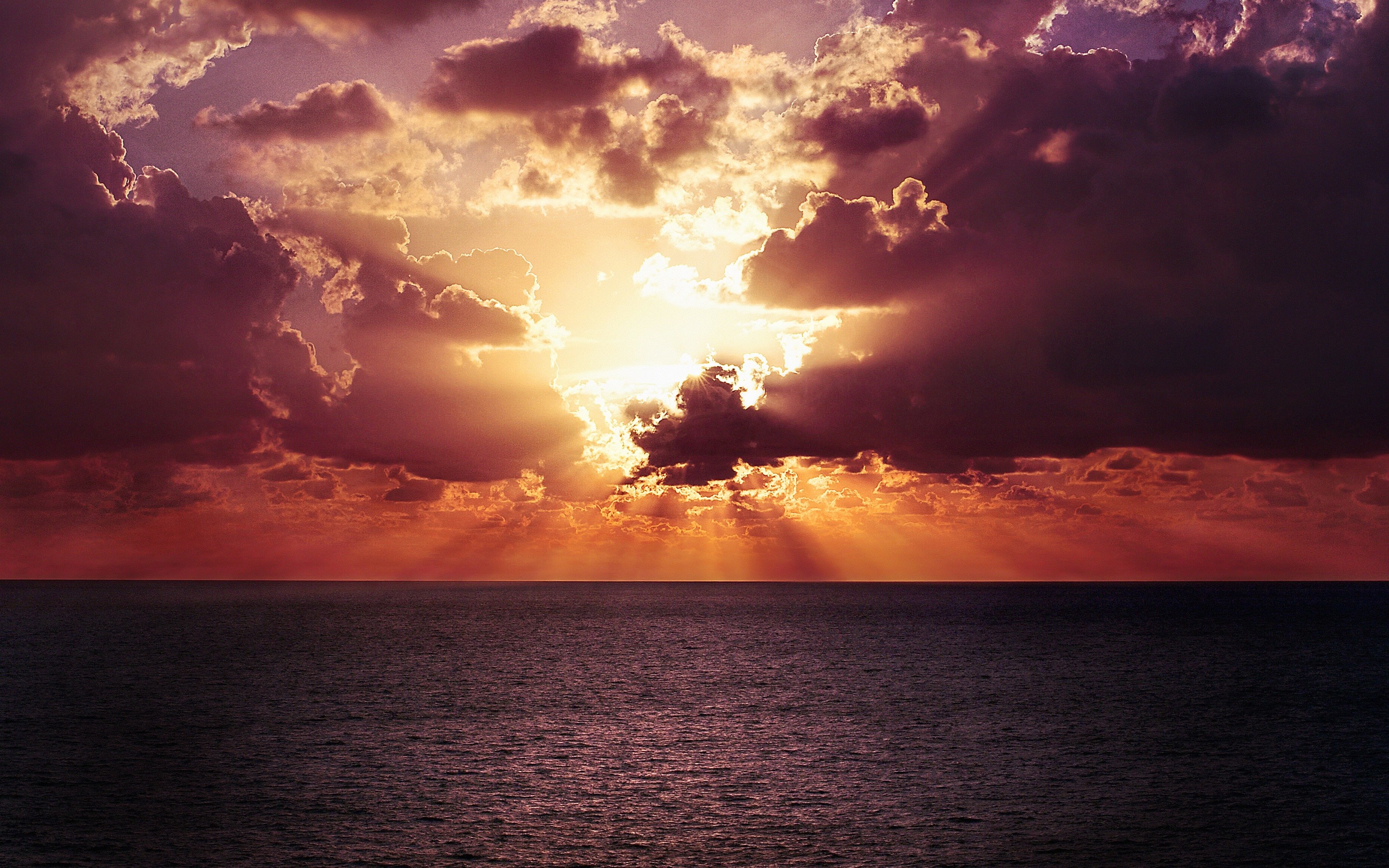 Sunset over the ocean with dramatic clouds HD Wallpaper