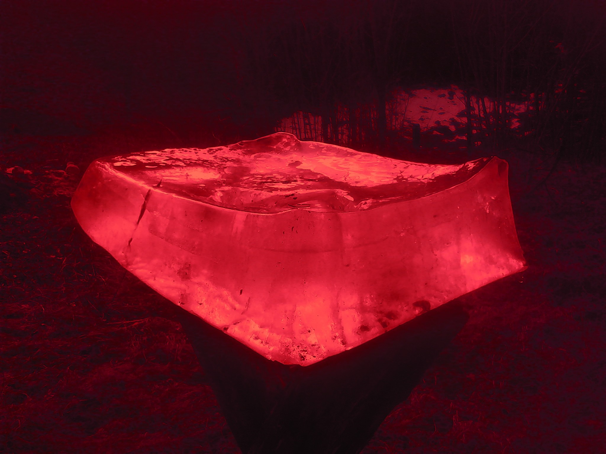 Red ice sculpture illuminated in darkness HD Wallpaper
