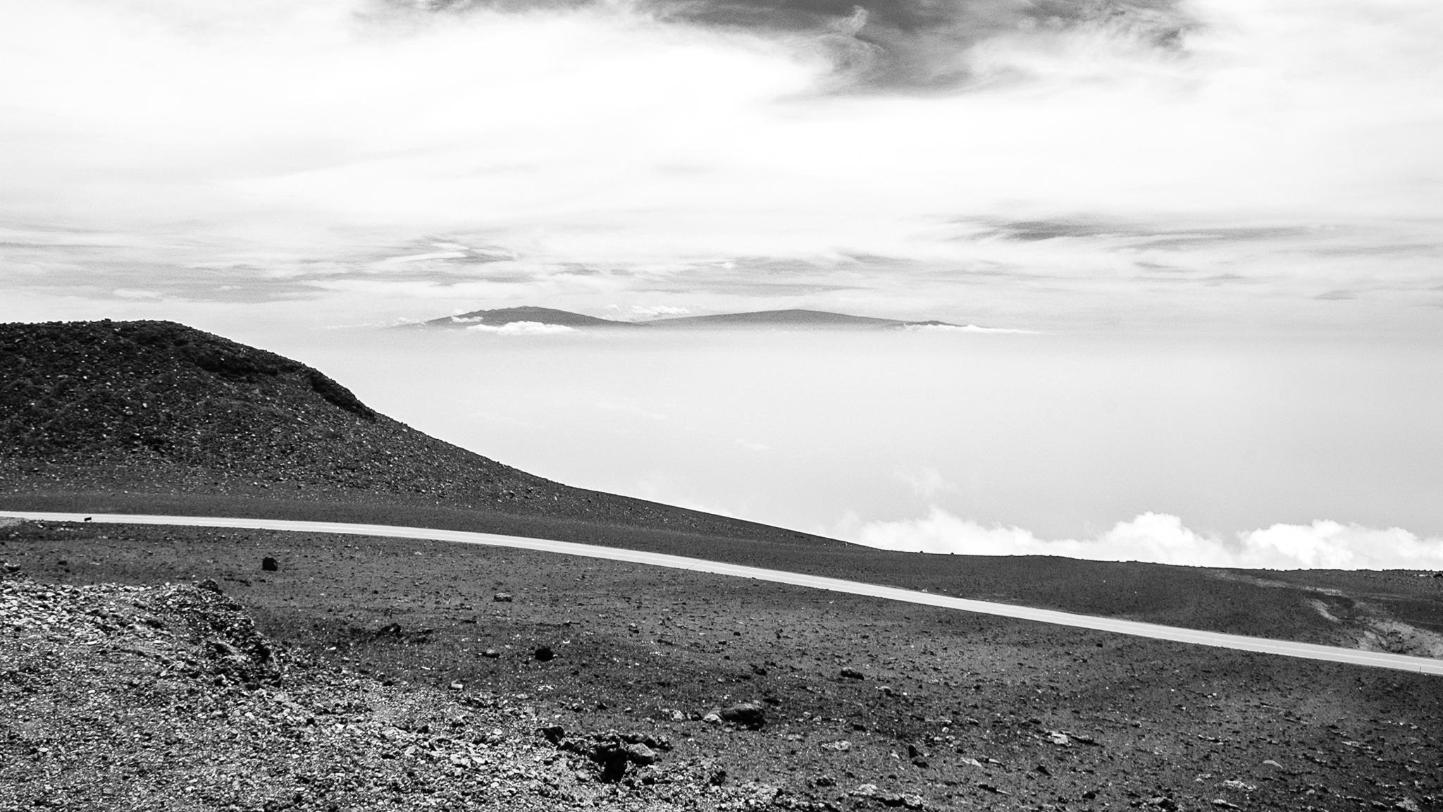 Mountain road above clouds with distant islands HD Wallpaper