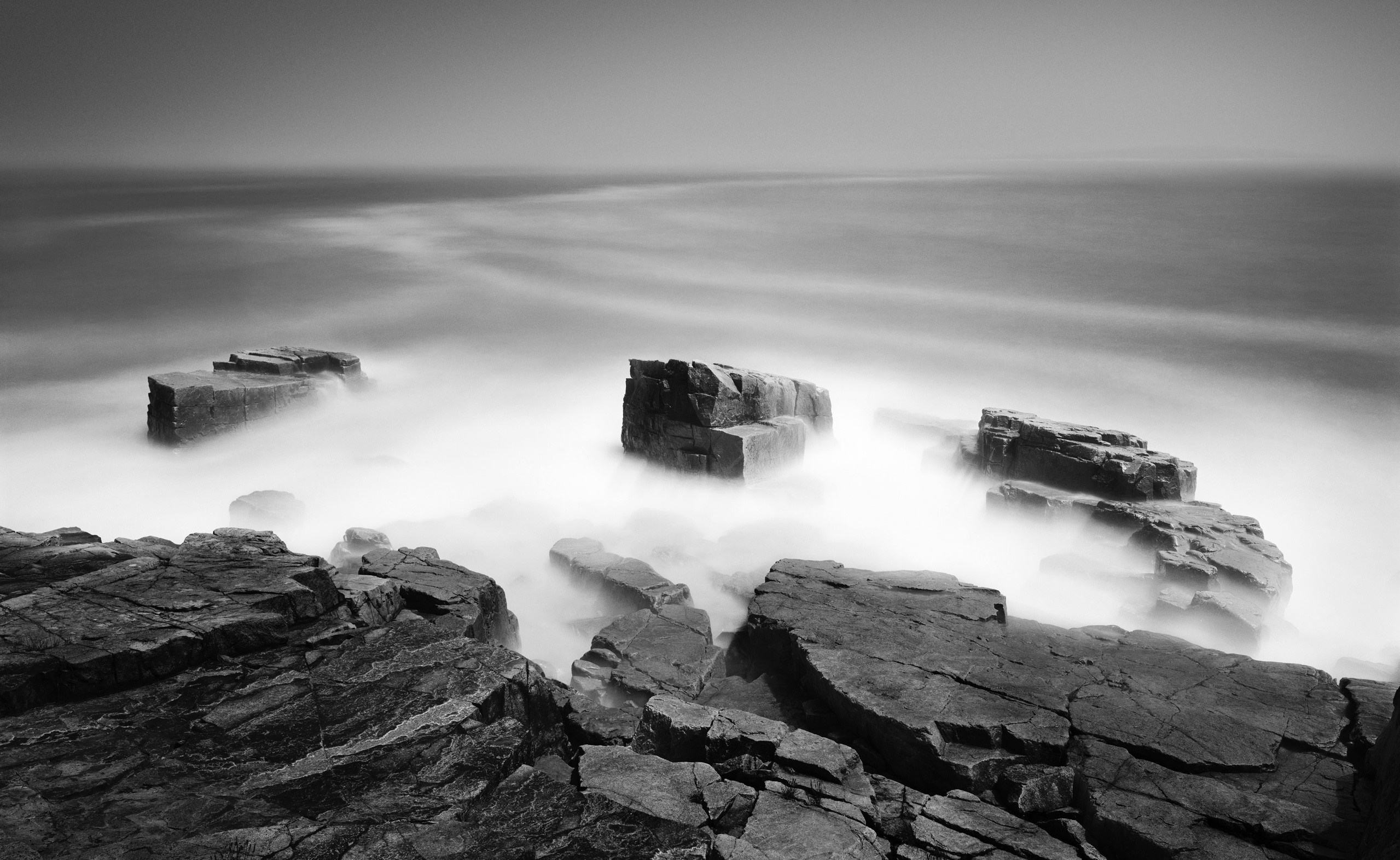 Monochrome seascape with rocks and misty ocean HD Wallpaper