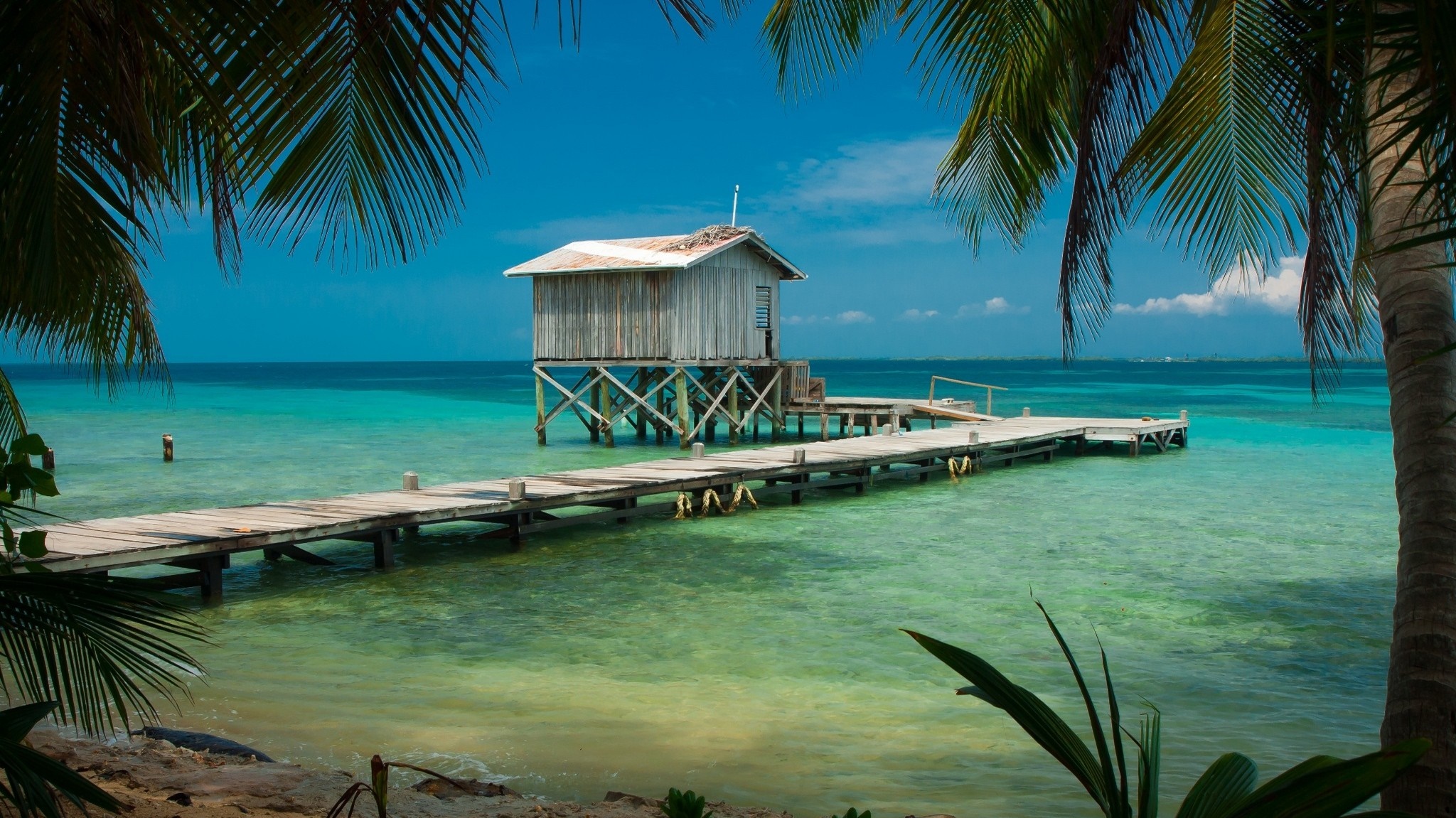 Wooden stilt house on a pier in the Caribbean Sea HD Wallpaper