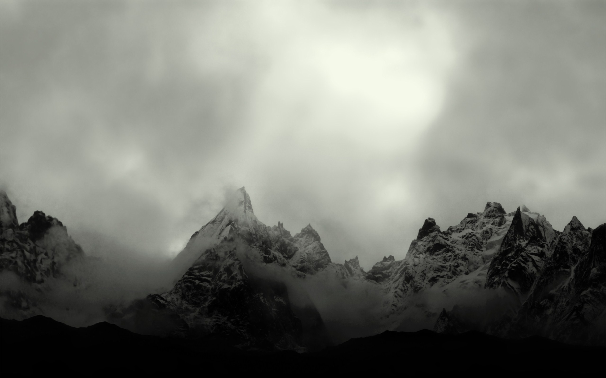 Monochrome mountain range shrouded in mist and clouds HD Wallpaper