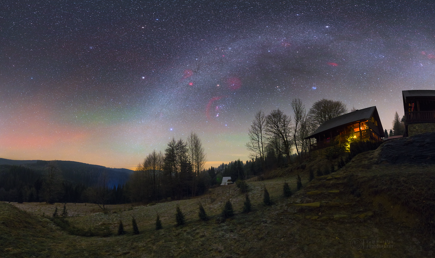 Milky Way over cabins in a forest at night HD Wallpaper
