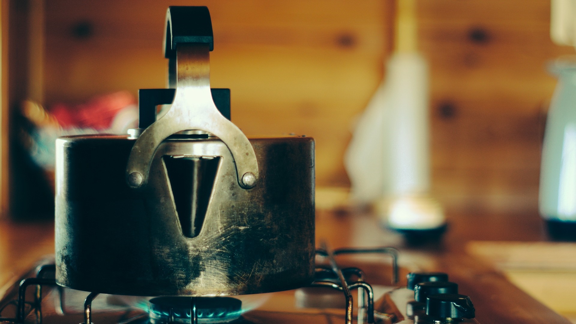 Kettle on a gas stove with blue flame HD Wallpaper