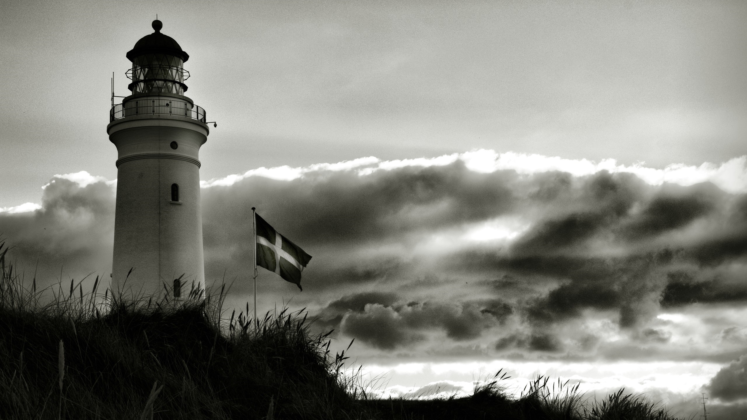 Lighthouse and Danish flag on a cloudy day HD Wallpaper
