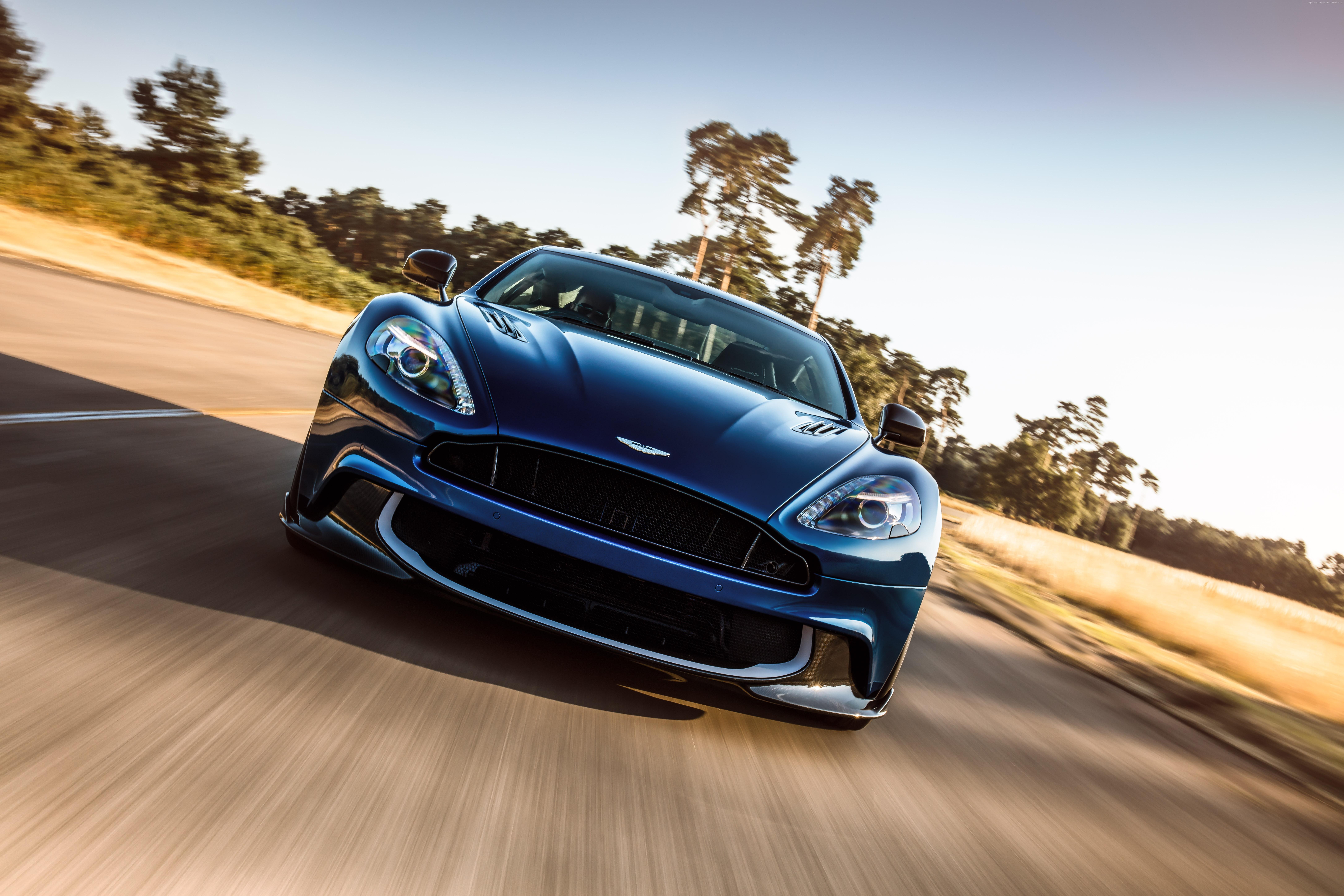 Blue Aston Martin Vanquish driving on a road HD Wallpaper