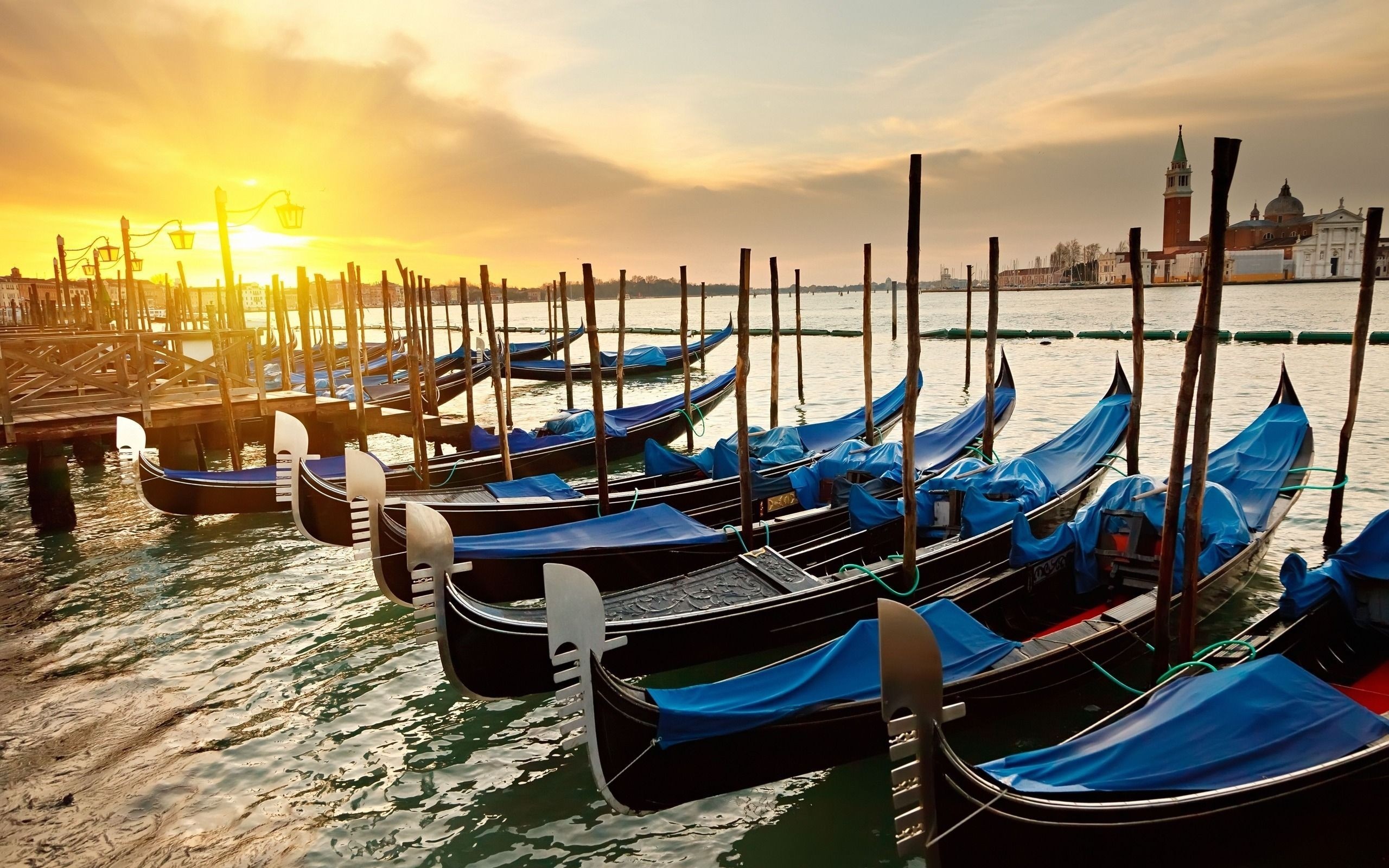 Gondolas docked in Venice at sunset HD Wallpaper