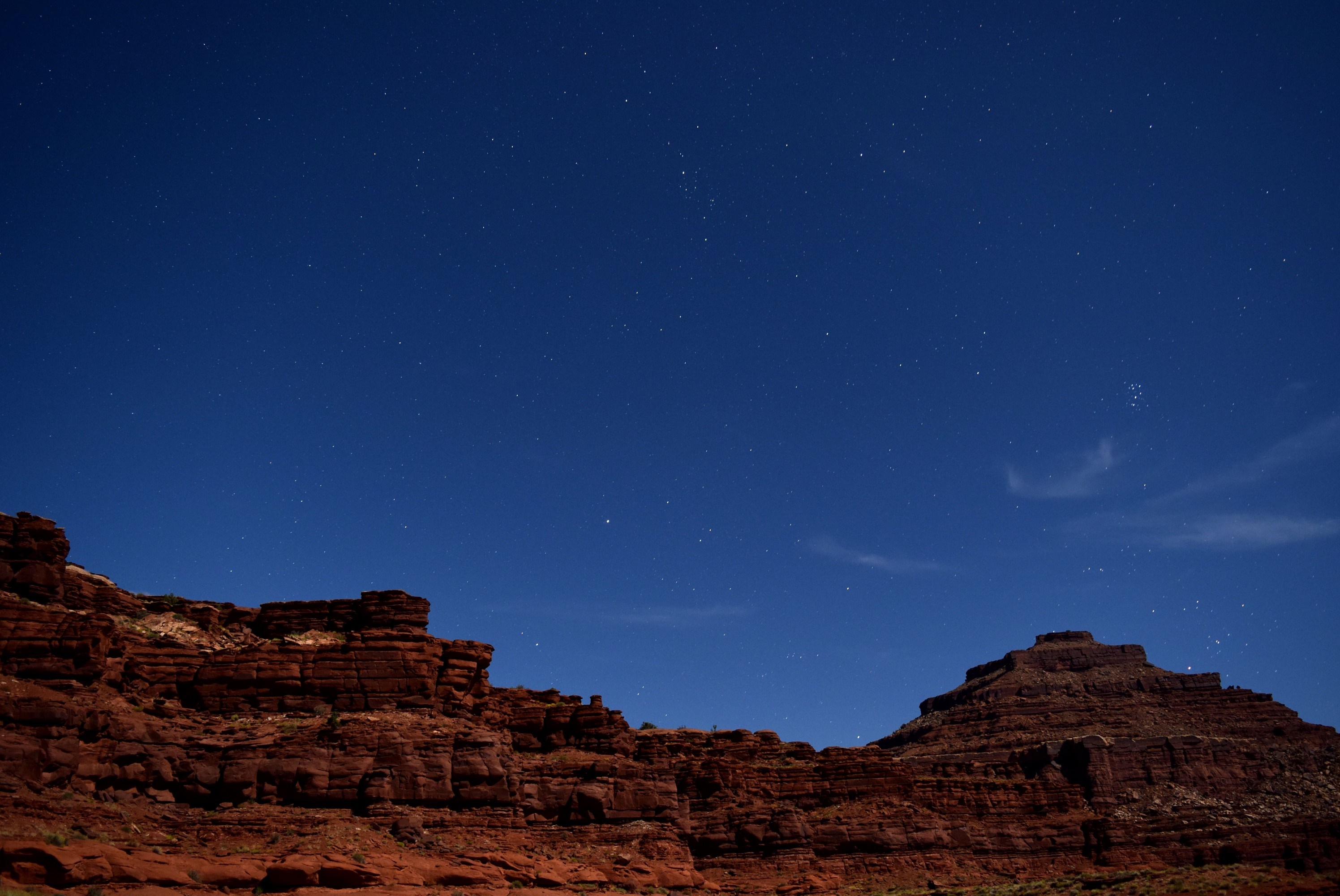 Red rock formations under a starry night sky HD Wallpaper