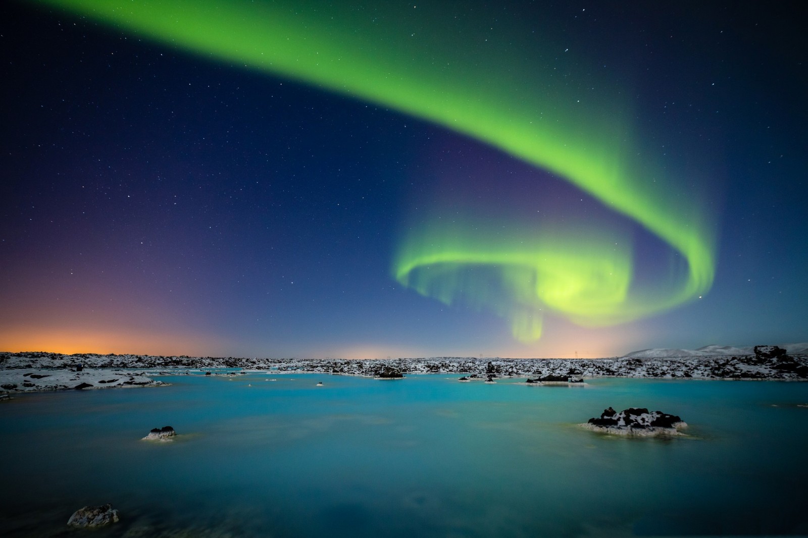 Aurora Borealis over a blue lagoon landscape HD Wallpaper