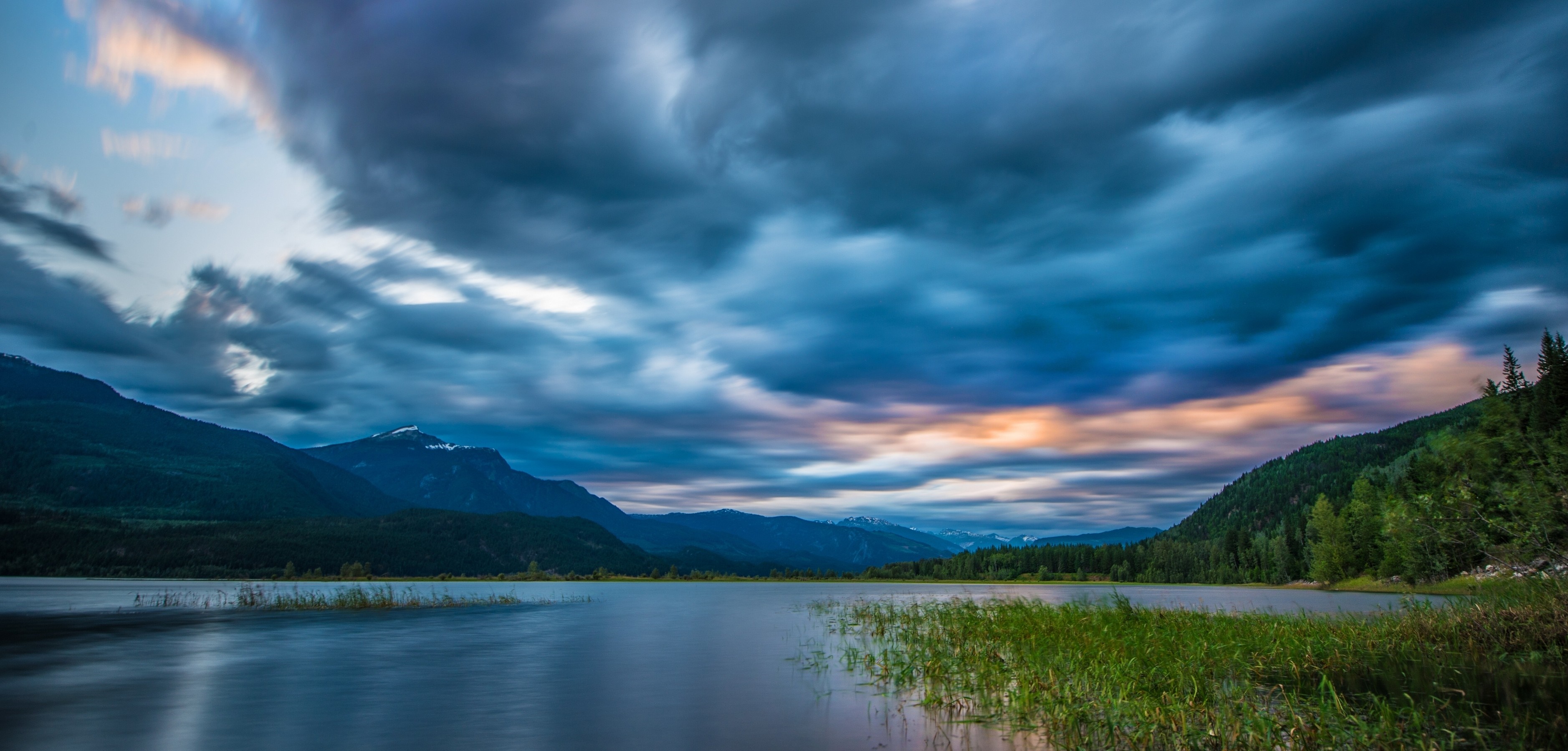 Lake and mountains under dramatic clouds HD Wallpaper