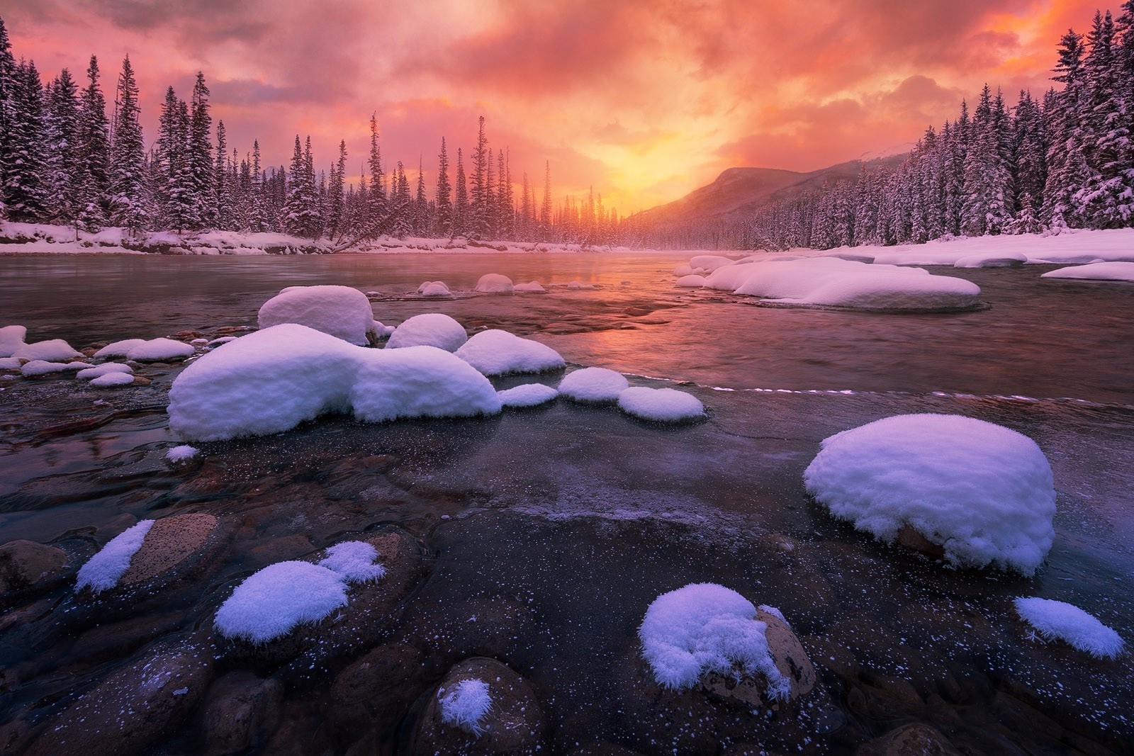 Winter sunrise over a snowy river in Banff National Park HD Wallpaper