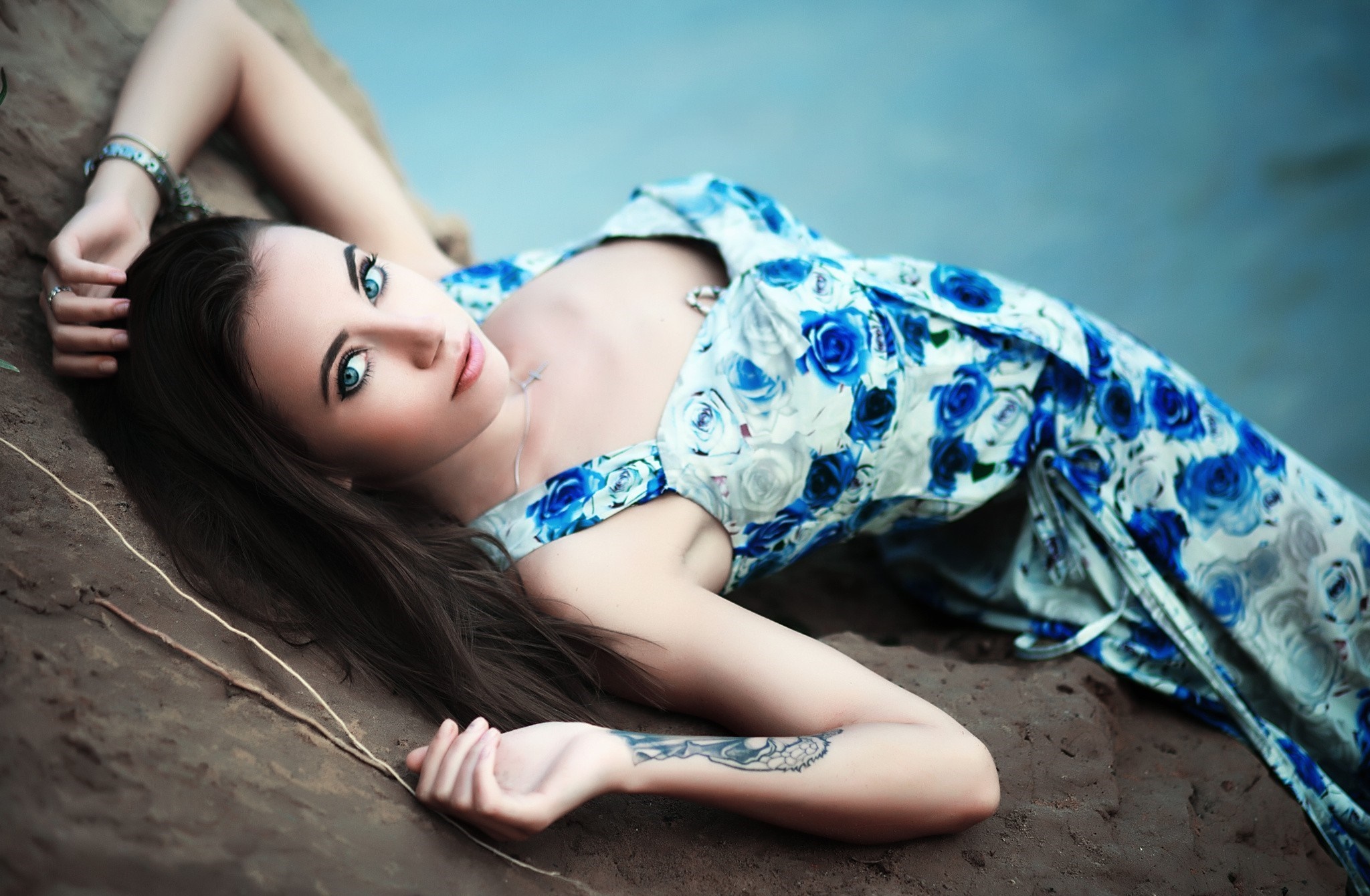 Woman in blue floral dress lying on the ground HD Wallpaper