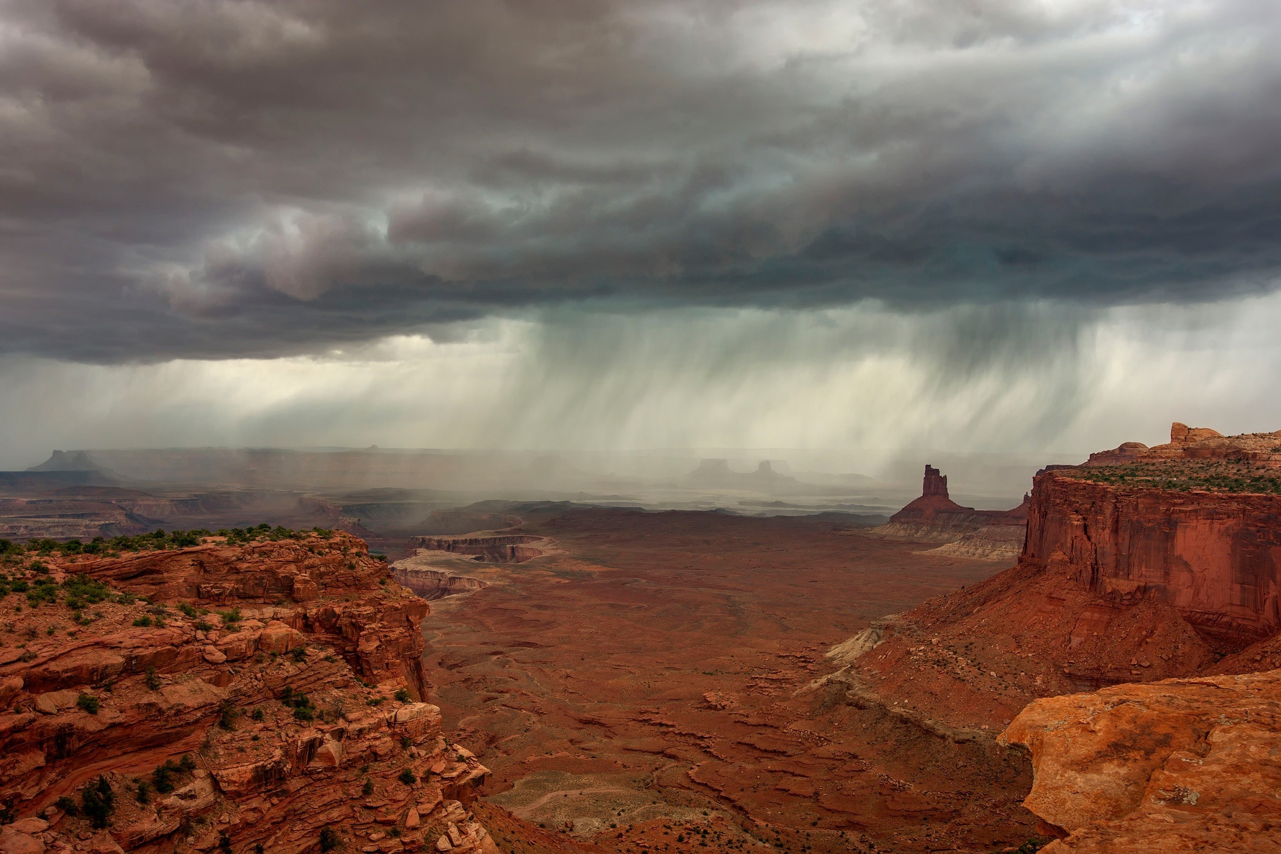 Desert landscape with rainstorm over mesas HD Wallpaper