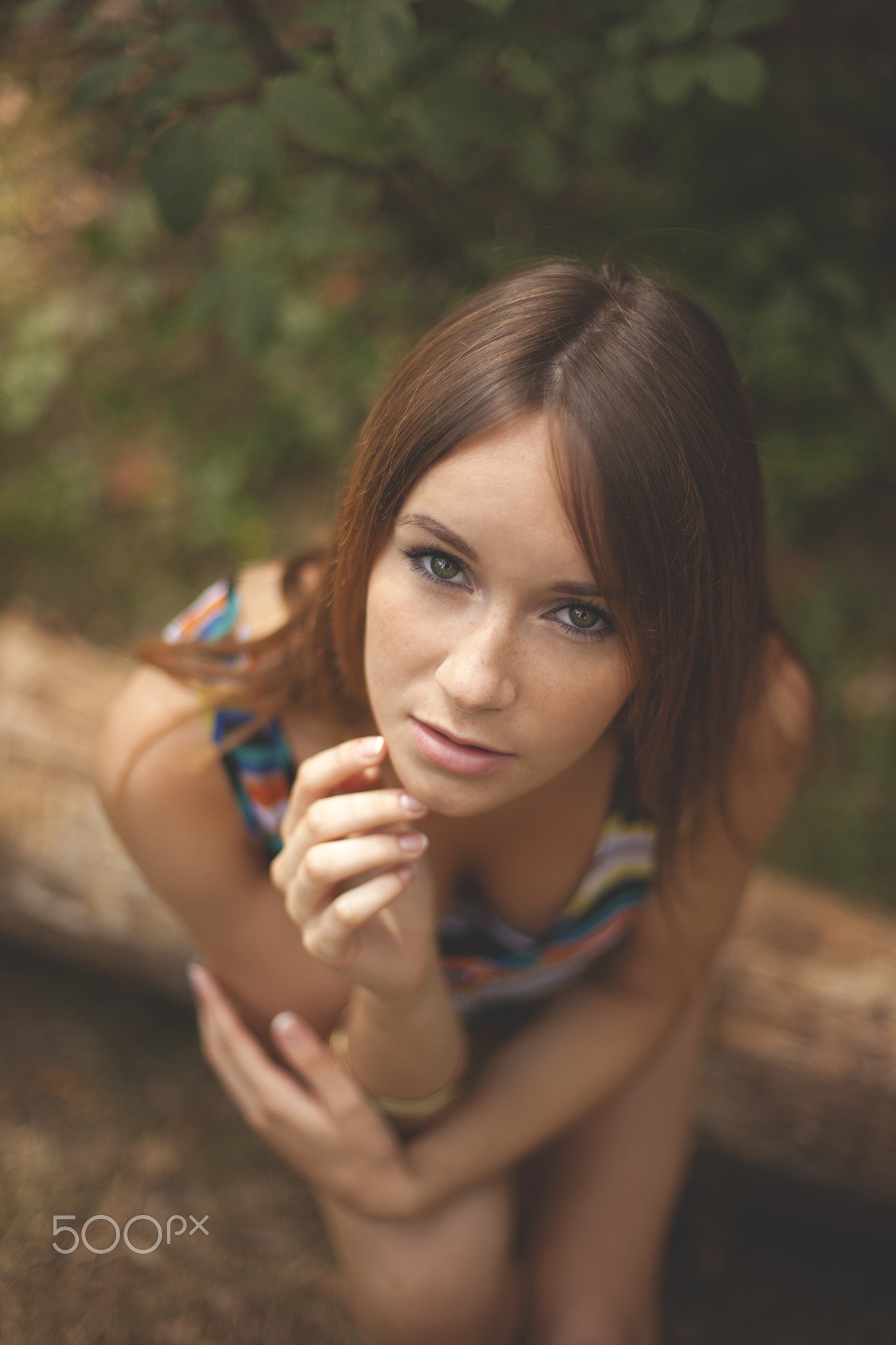 Woman with long brown hair and blue eyes looking up HD Wallpaper