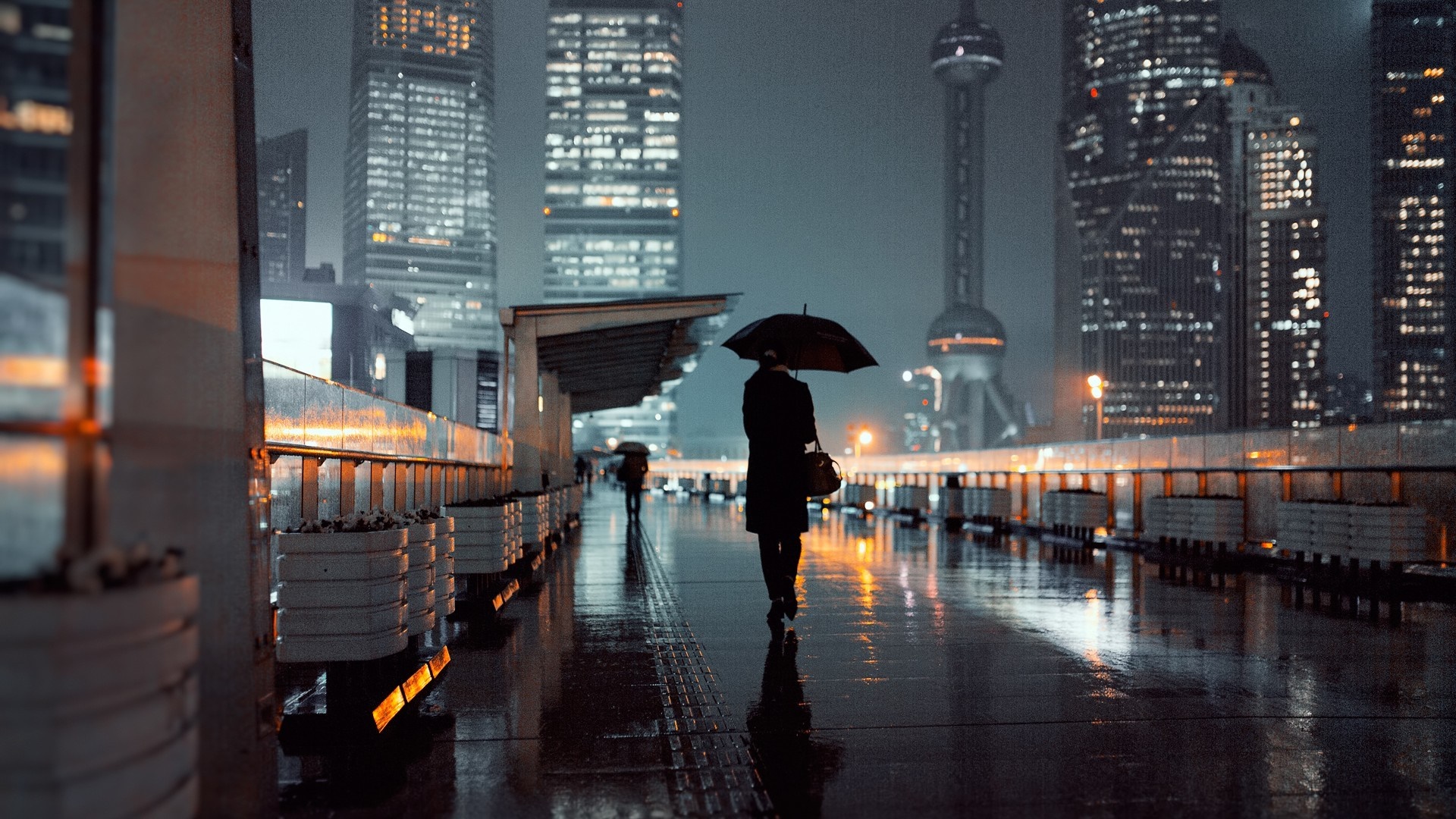 Person with umbrella walking on wet city street at night HD Wallpaper