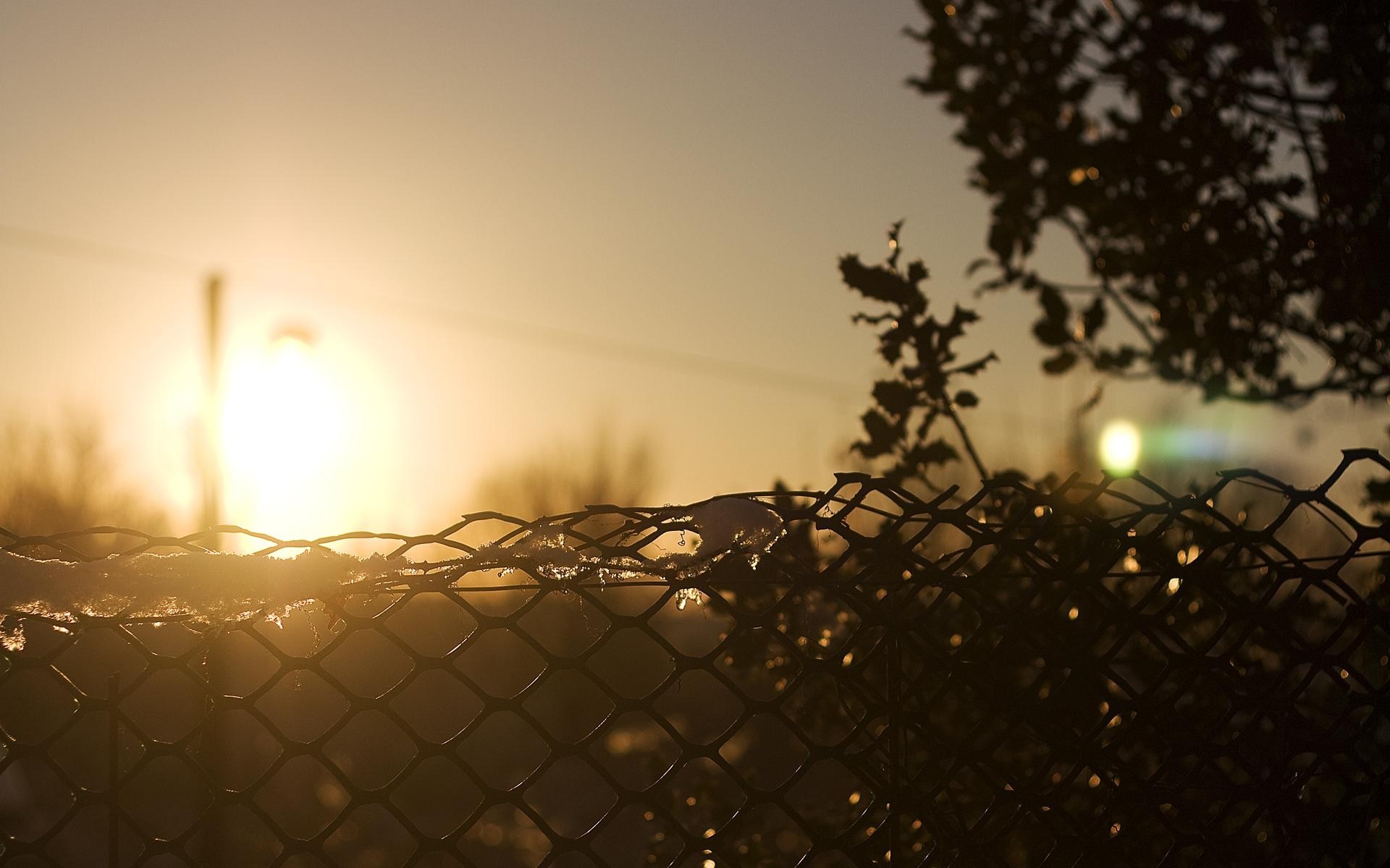Sunset over a chain-link fence with snow HD Wallpaper