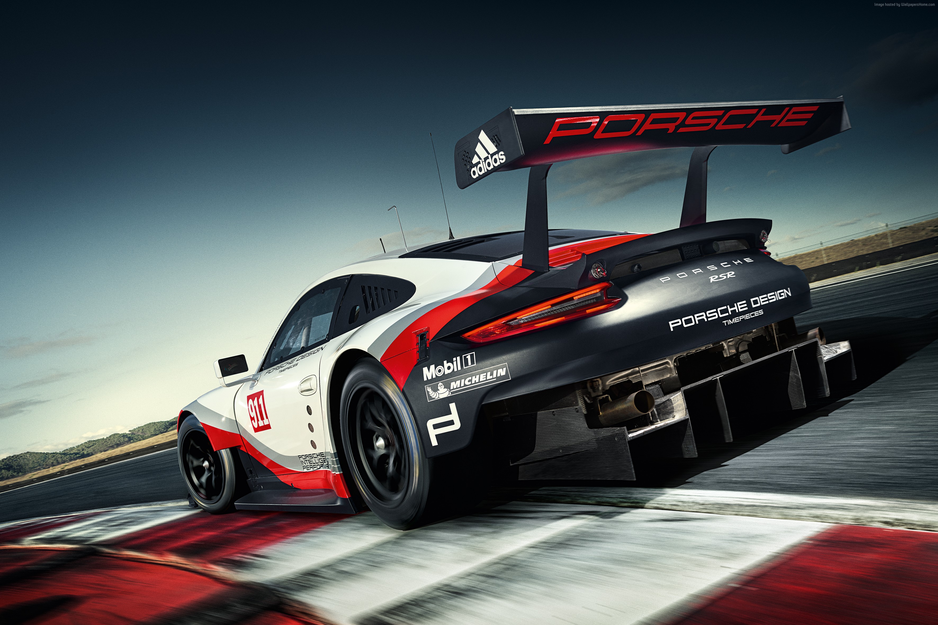 Porsche 911 RSR racing on a track HD Wallpaper