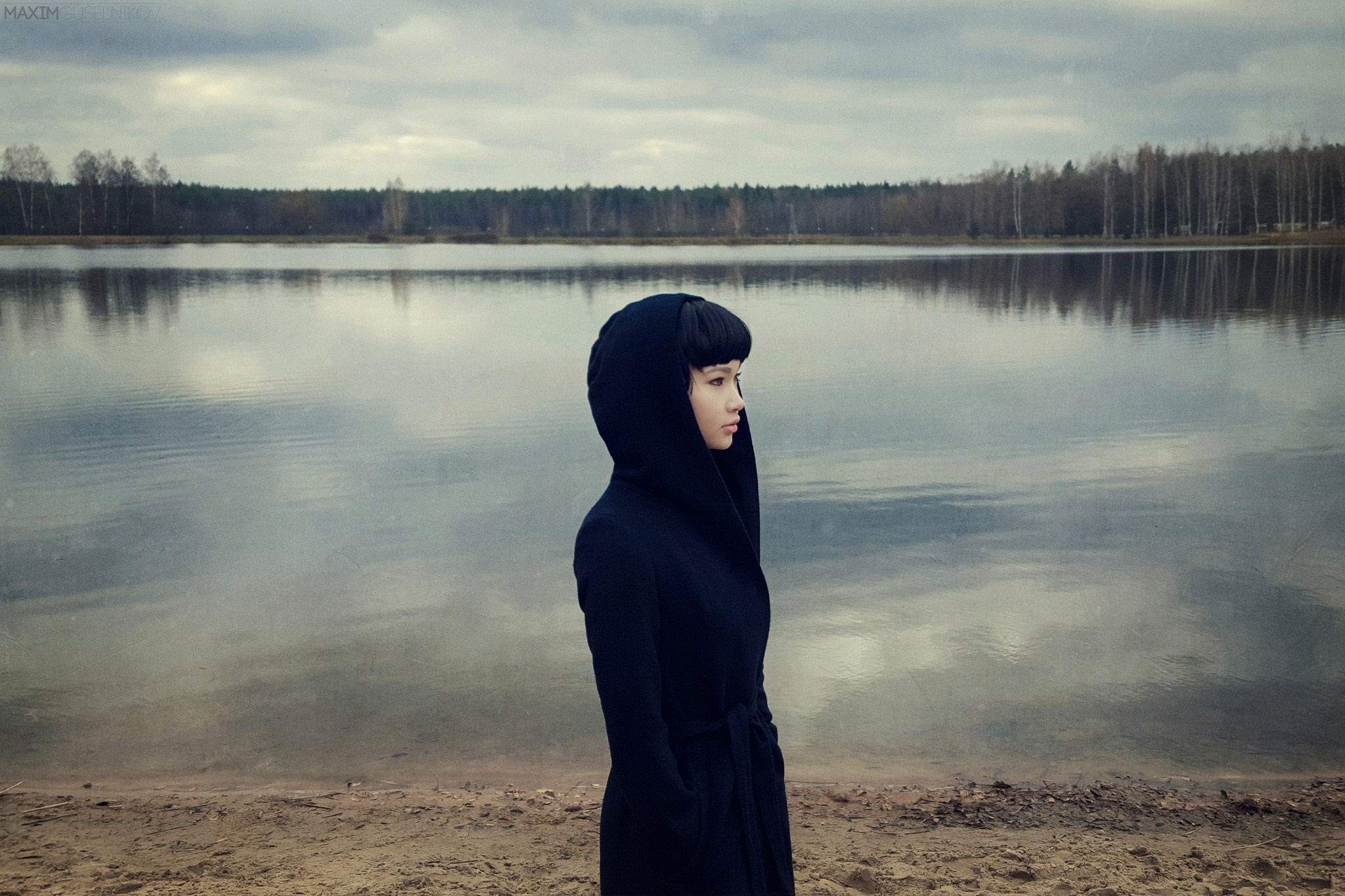 Woman in black coat by a lake HD Wallpaper