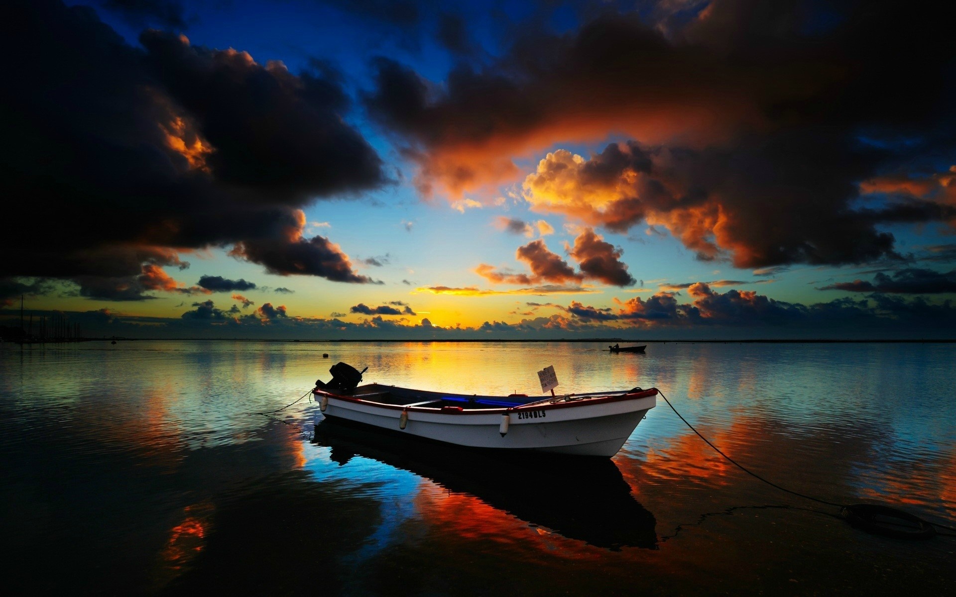 Boat on the water at sunset with dramatic clouds HD Wallpaper