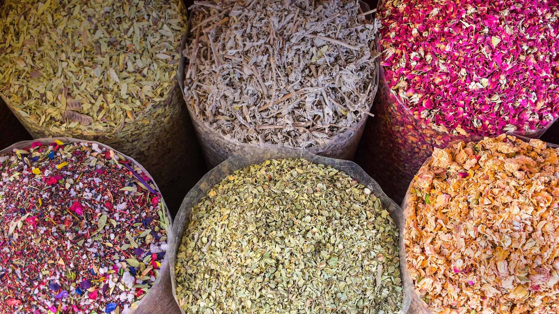 Bags of dried herbs and flower petals at a market HD Wallpaper