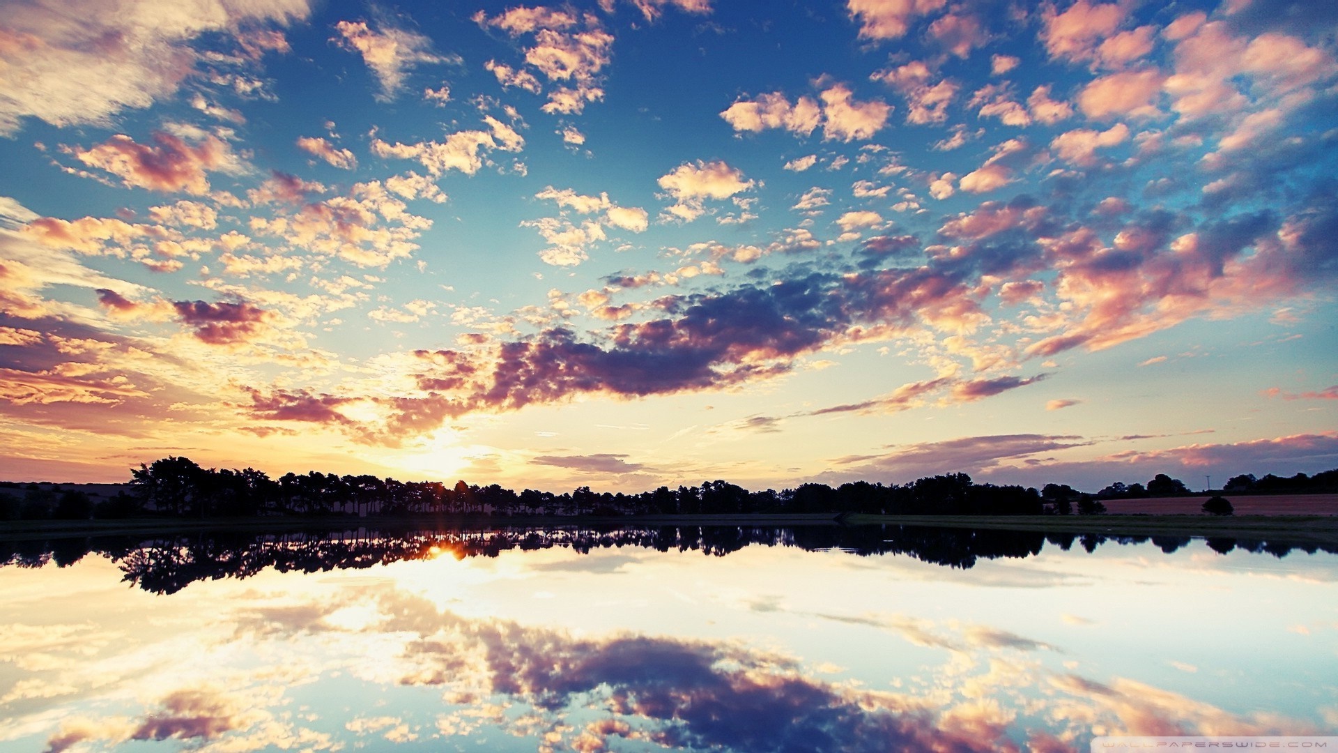 Sunset reflected in a lake with colorful clouds HD Wallpaper