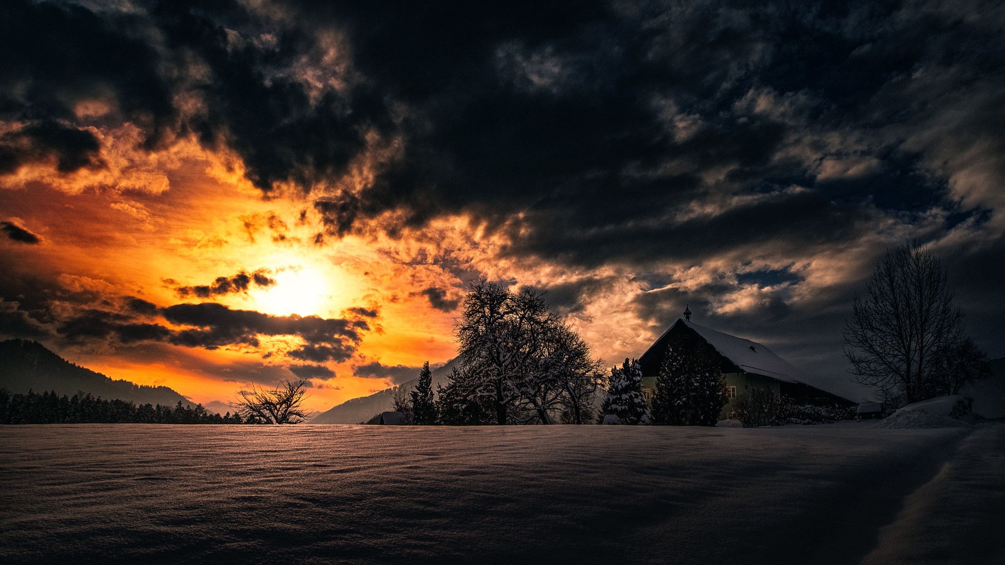 Sunset over a snowy landscape with a house HD Wallpaper