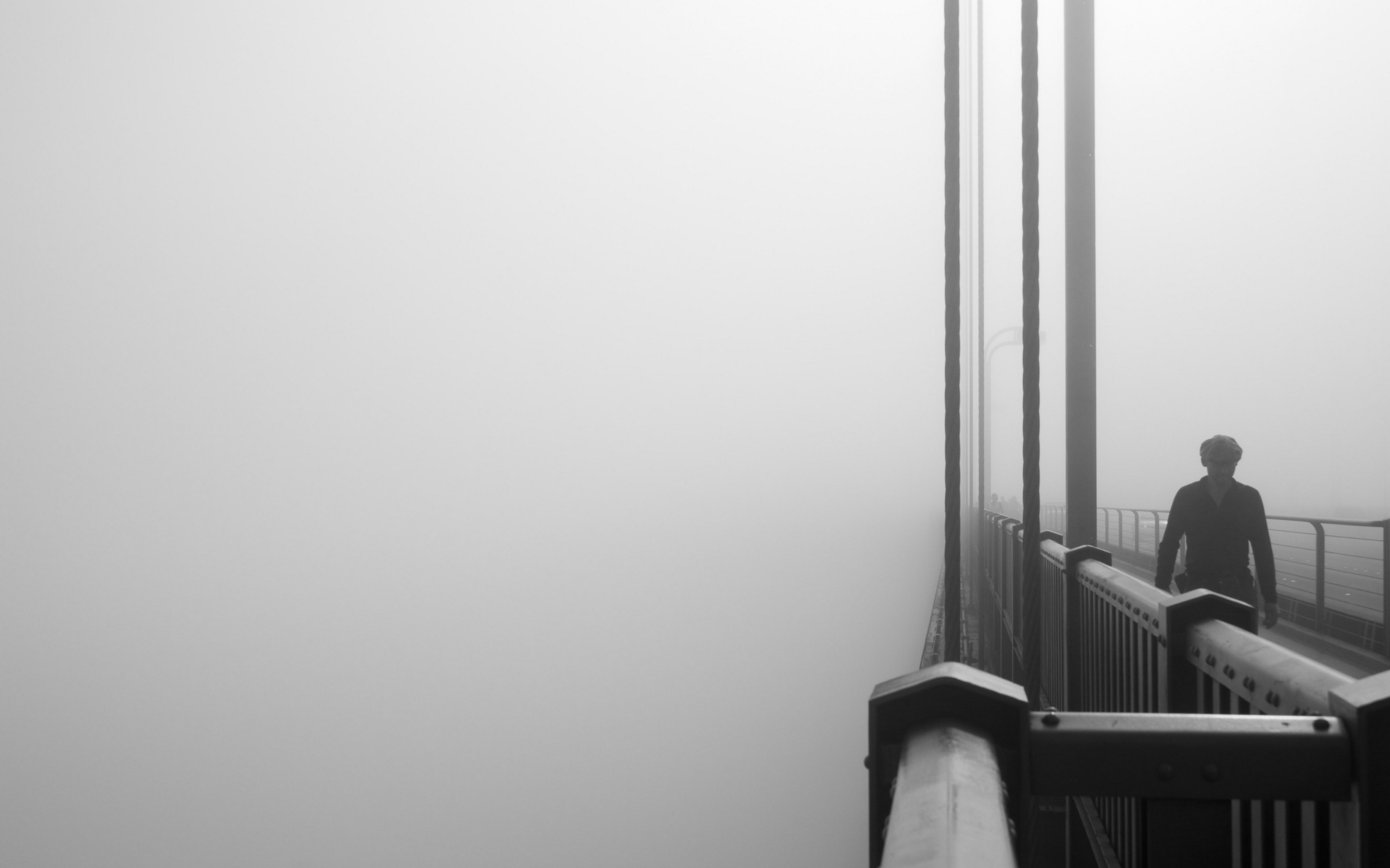Man walking on a foggy bridge HD Wallpaper