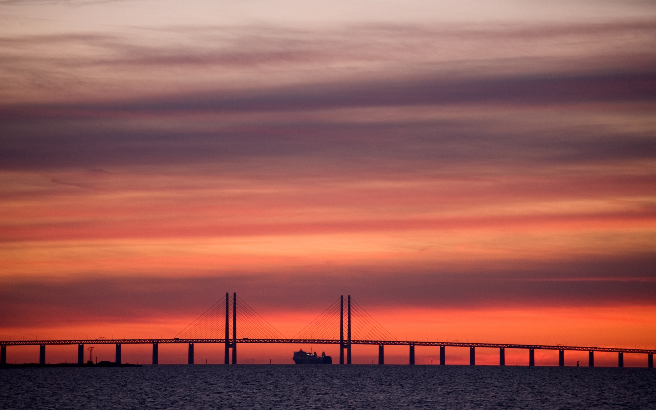 Bridge over water at sunset with ship silhouette HD Wallpaper