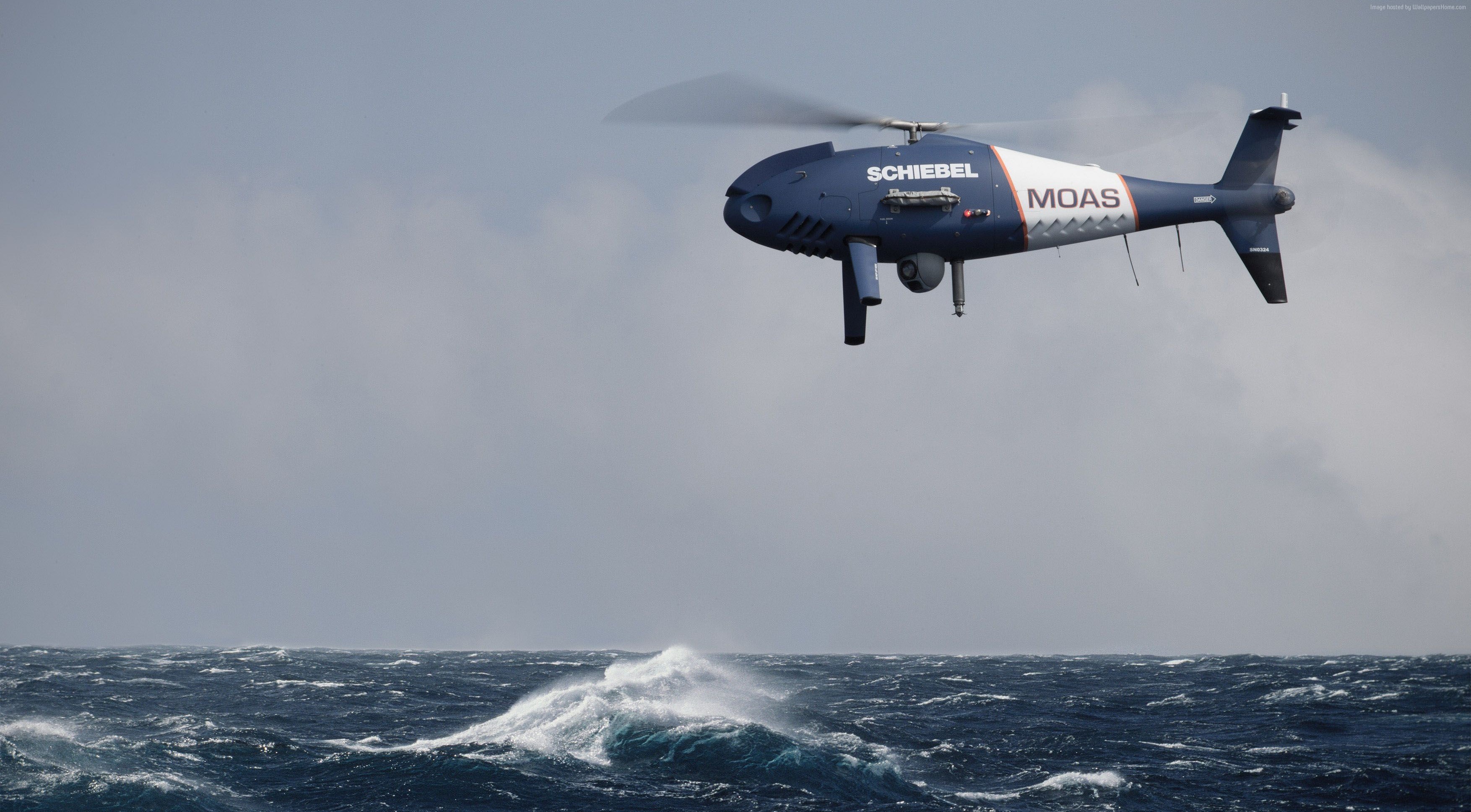 Schiebel S-100 Camcopter MOAS drone over rough sea HD Wallpaper