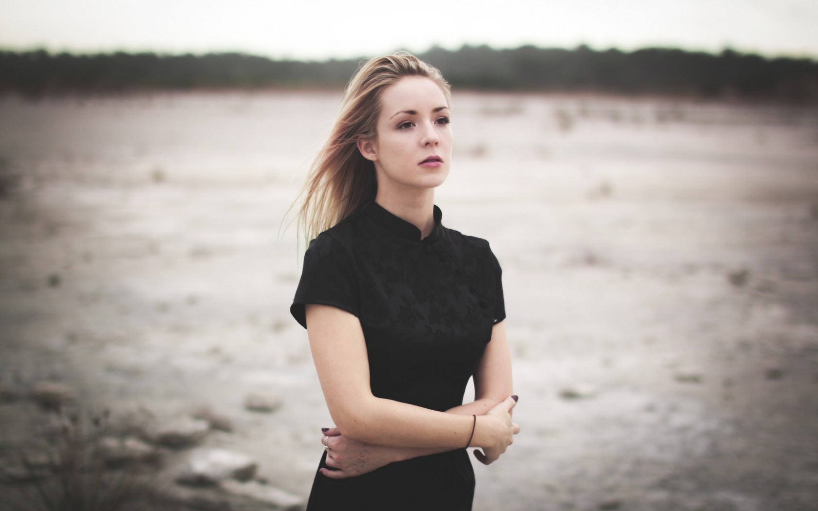 Woman in black dress standing outdoors HD Wallpaper