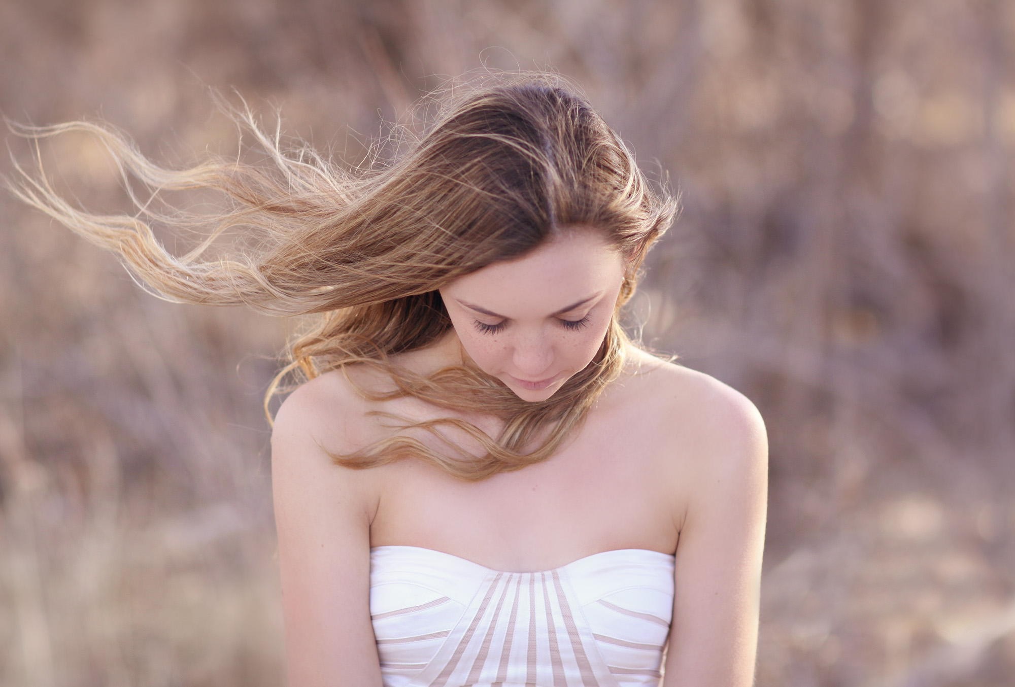 Woman with windblown hair in a white dress HD Wallpaper