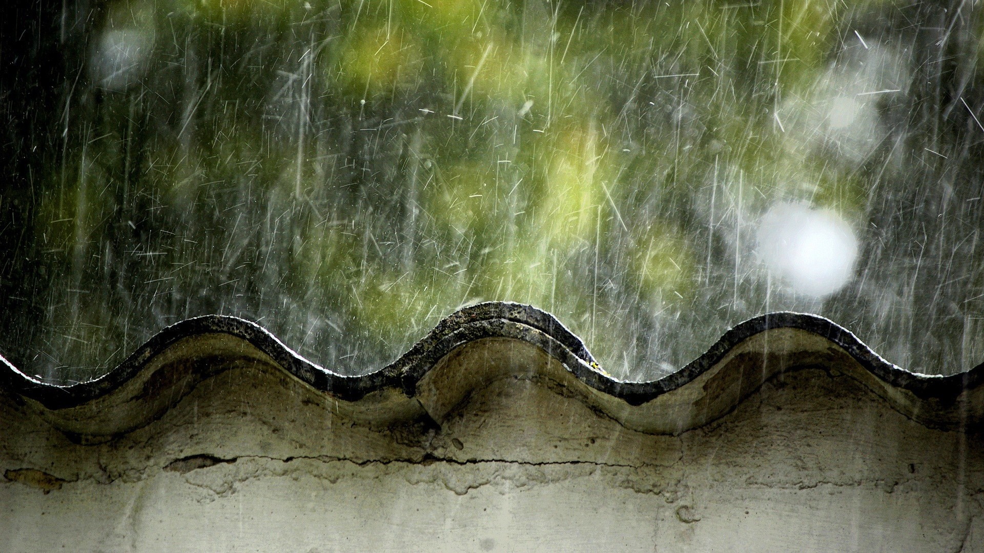 Rain falling on a wavy roof with green foliage background HD Wallpaper