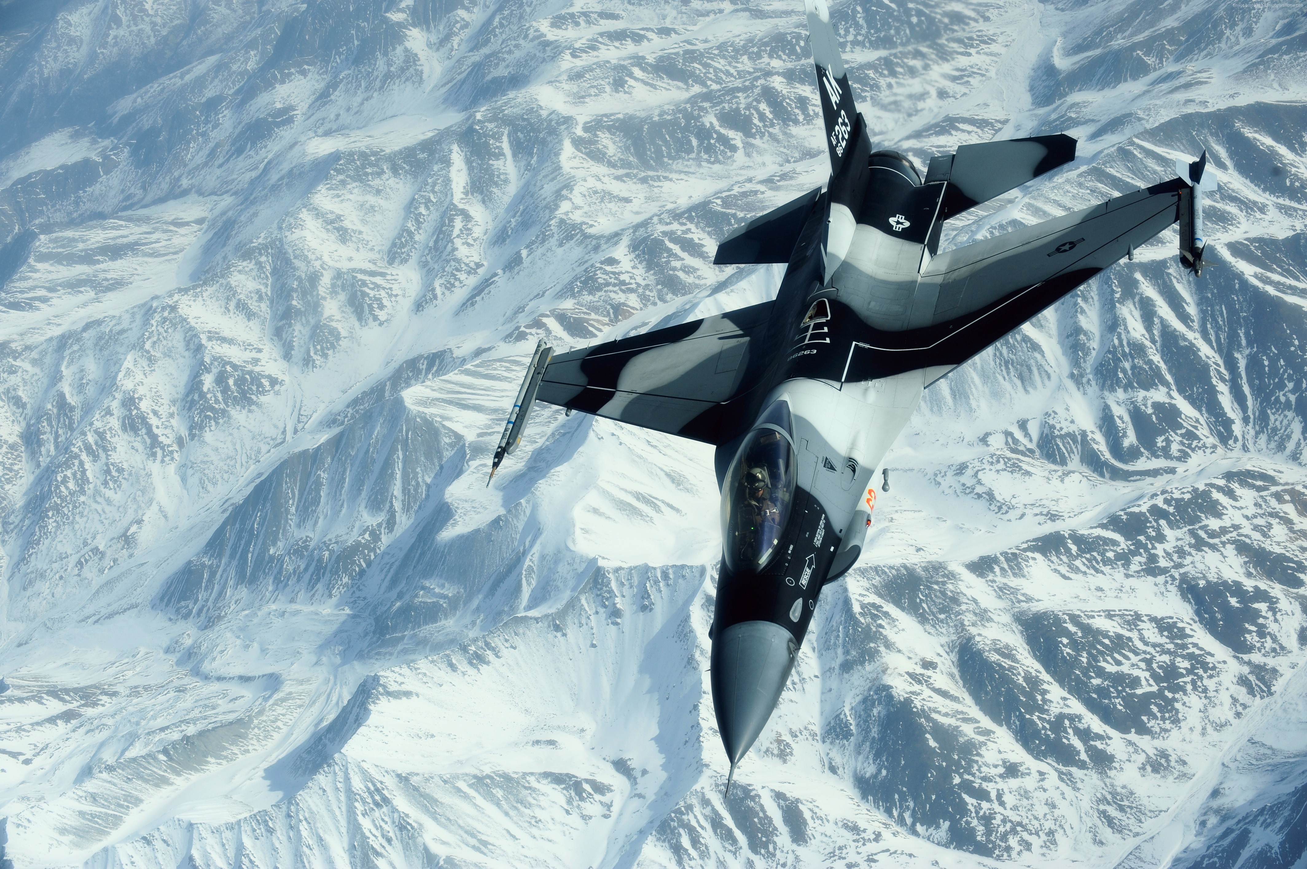 F-16 Fighting Falcon over snow-covered mountains HD Wallpaper