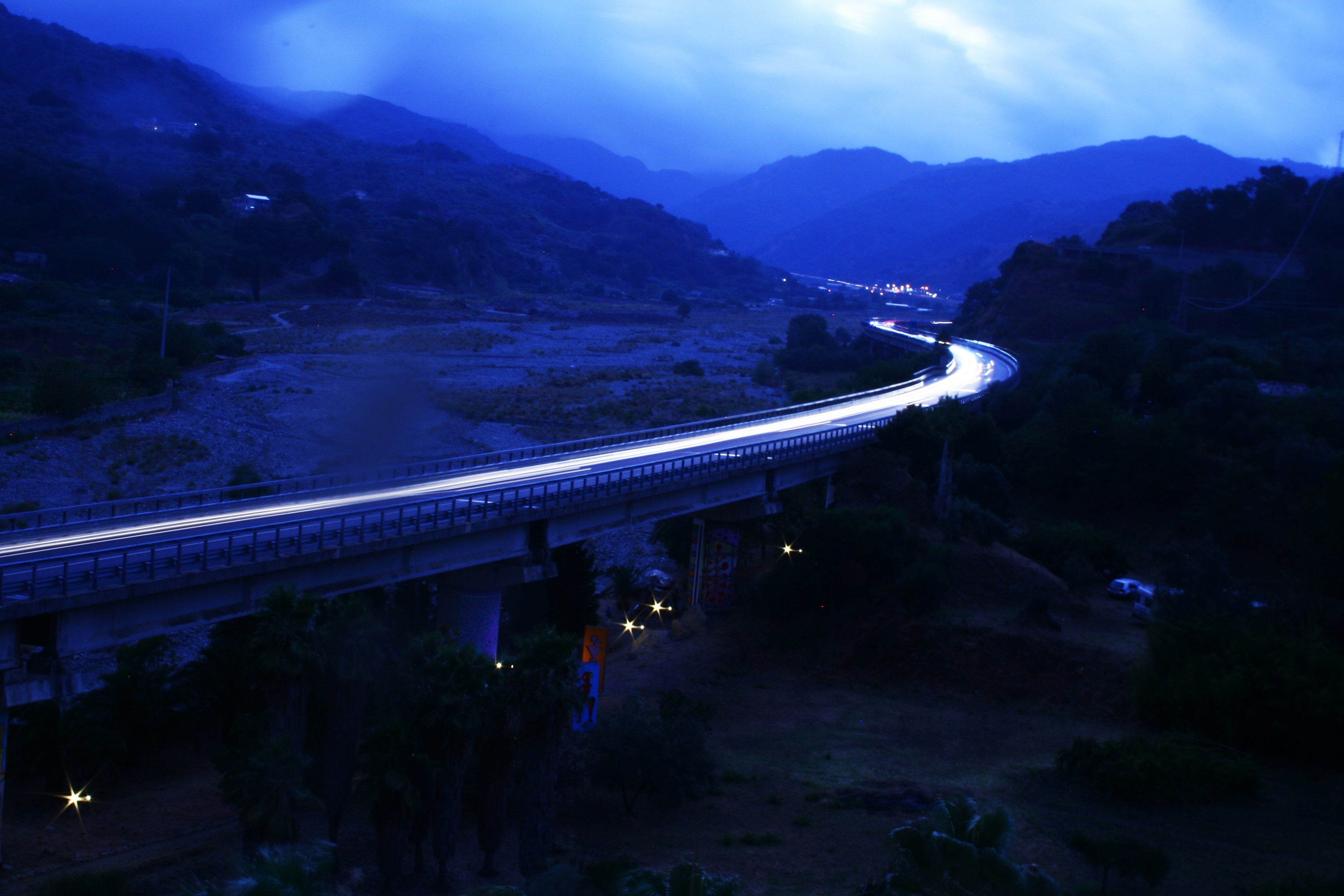 Long exposure of a bridge over a valley at night HD Wallpaper