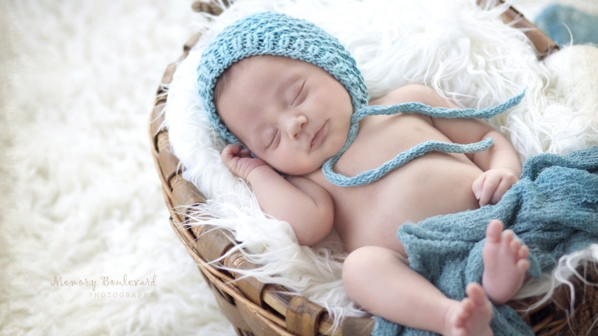 Baby sleeping in a basket with a blue hat HD Wallpaper