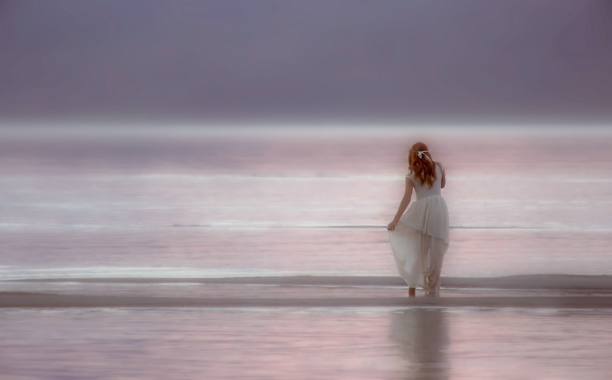 Woman in white dress on a misty beach at sunrise HD Wallpaper