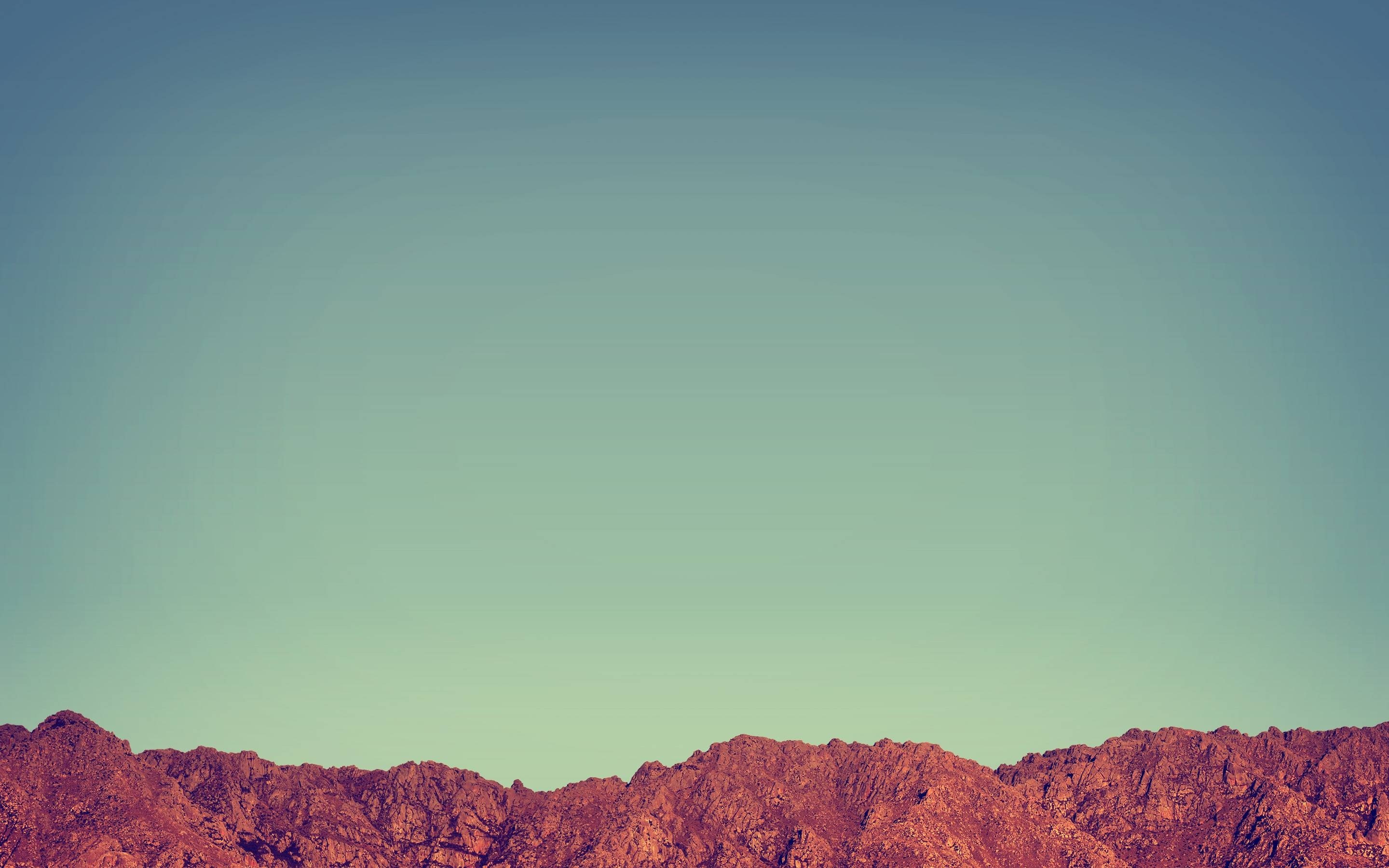 Rocky mountain range under a clear sky HD Wallpaper
